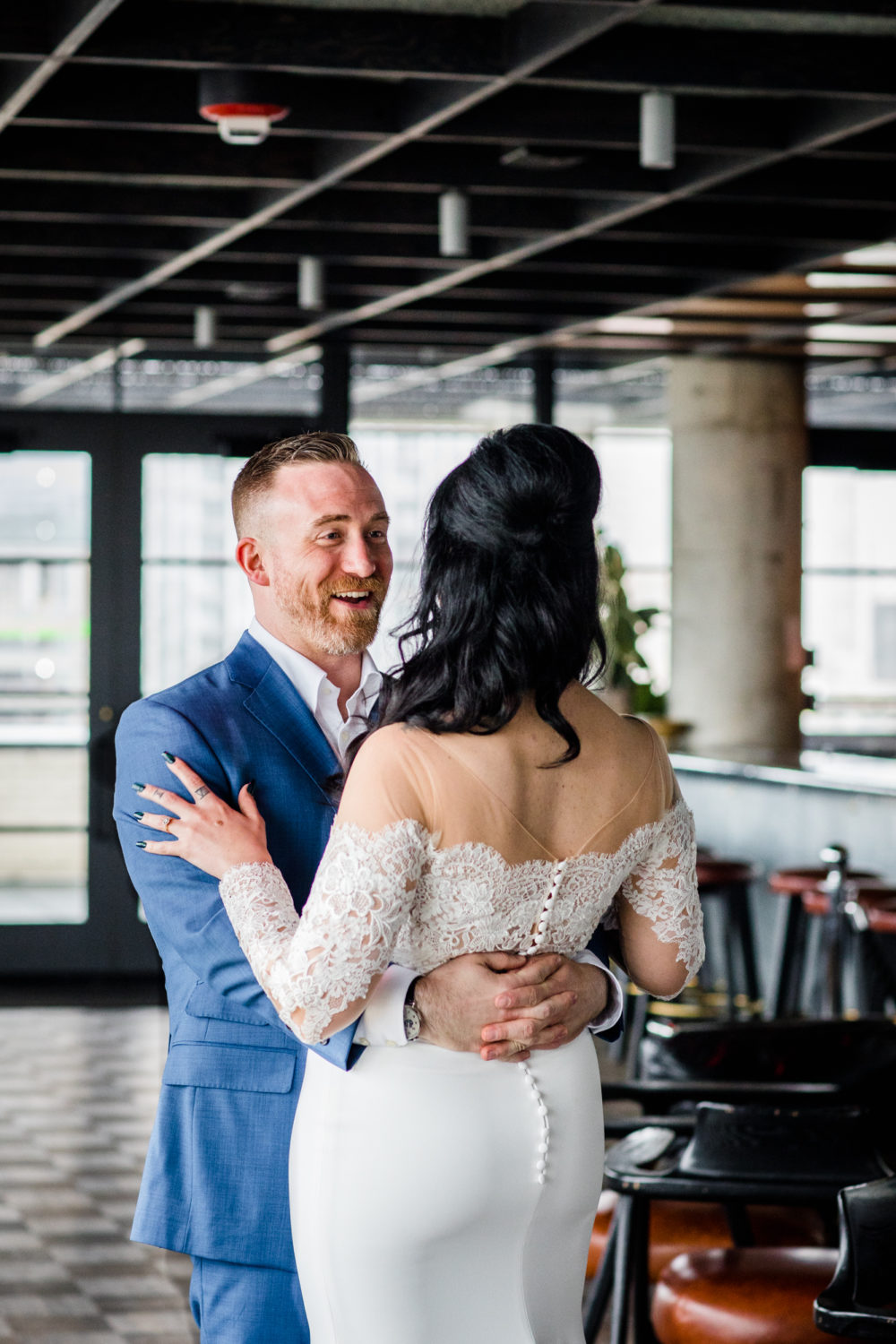 A groom reacts to seeing his bridge for the first time at the Ace Hotel bar in Chicago. 