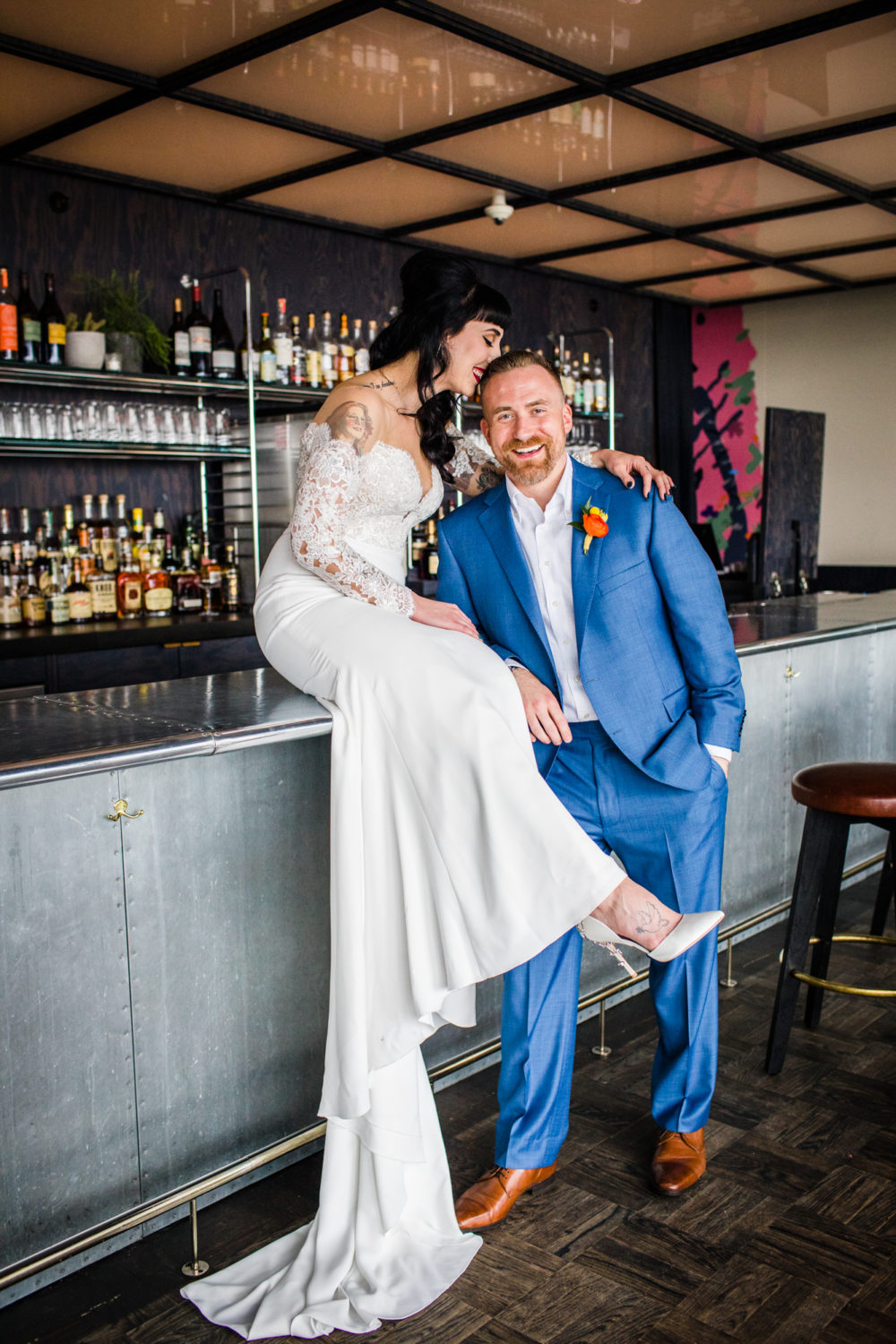 A couple poses for a portrait on the bar at the Ace Hotel before their wedding in Chicago. 