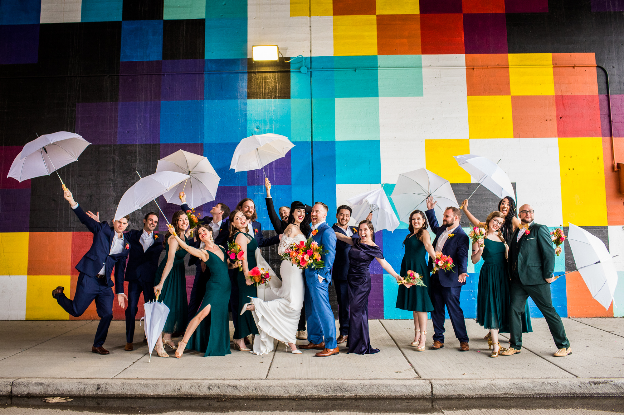 A wedding party recreates a Singing in the Rain photo in front of a Pantone wall in Chicago. 