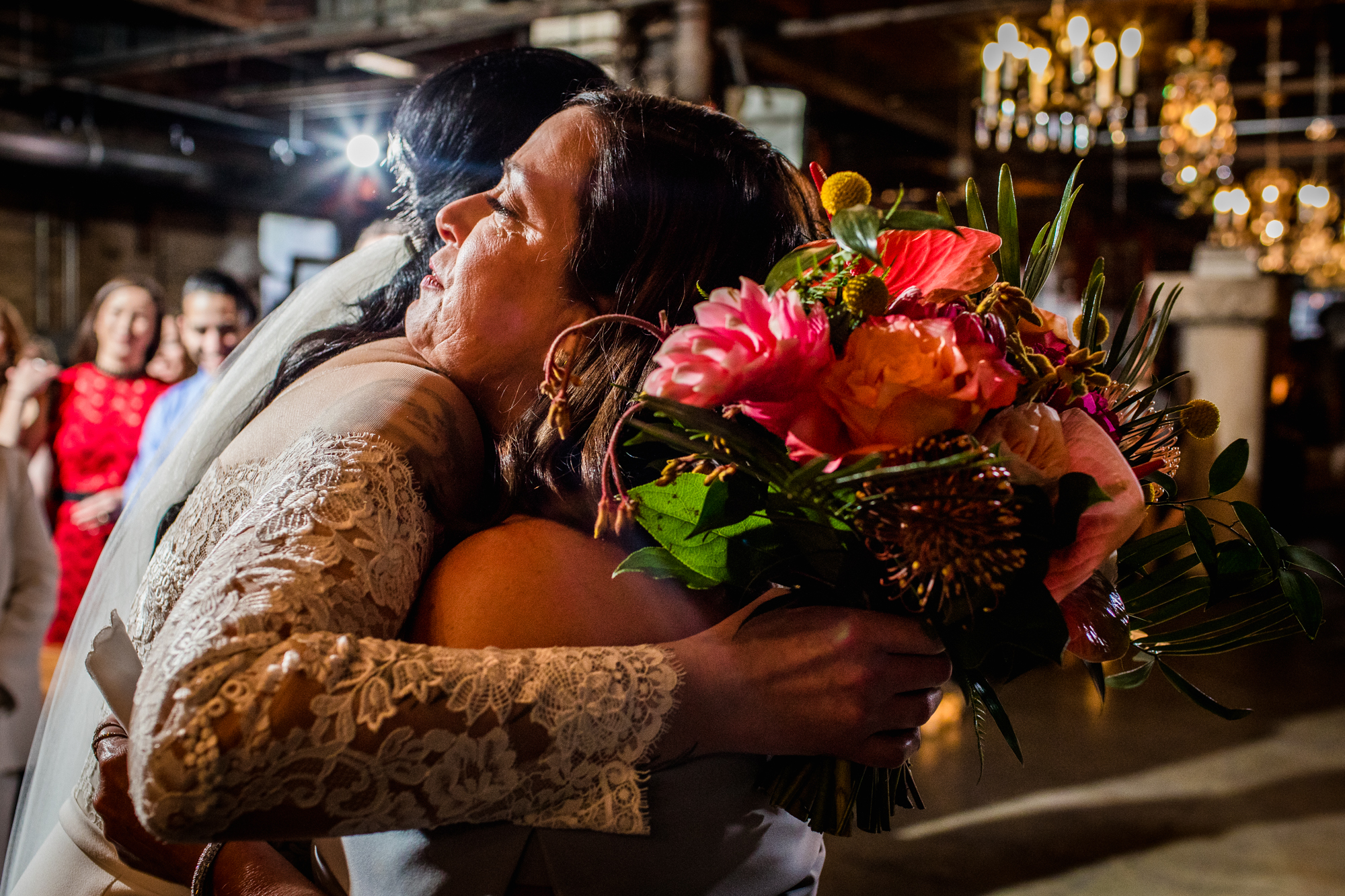 A bride hugs her mom after walking down the aisle during a Salvage One wedding ceremony. 