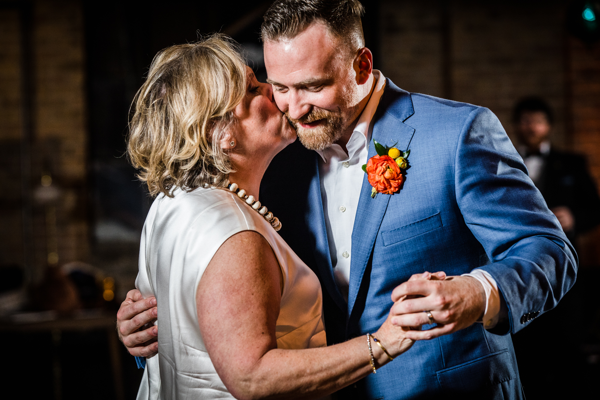 A groom shares his first dance with his mom at a Salvage One wedding reception. 