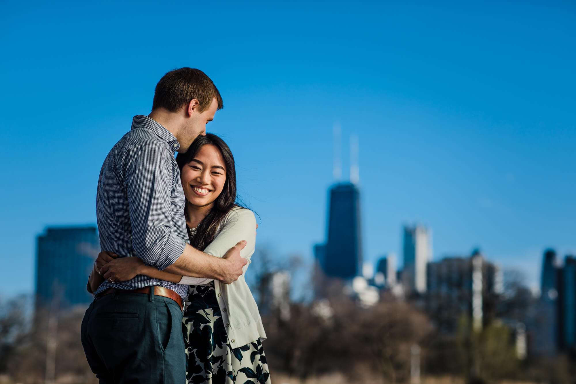 Couple embrace during spring engagement shoot in Lincoln Park, Chicago