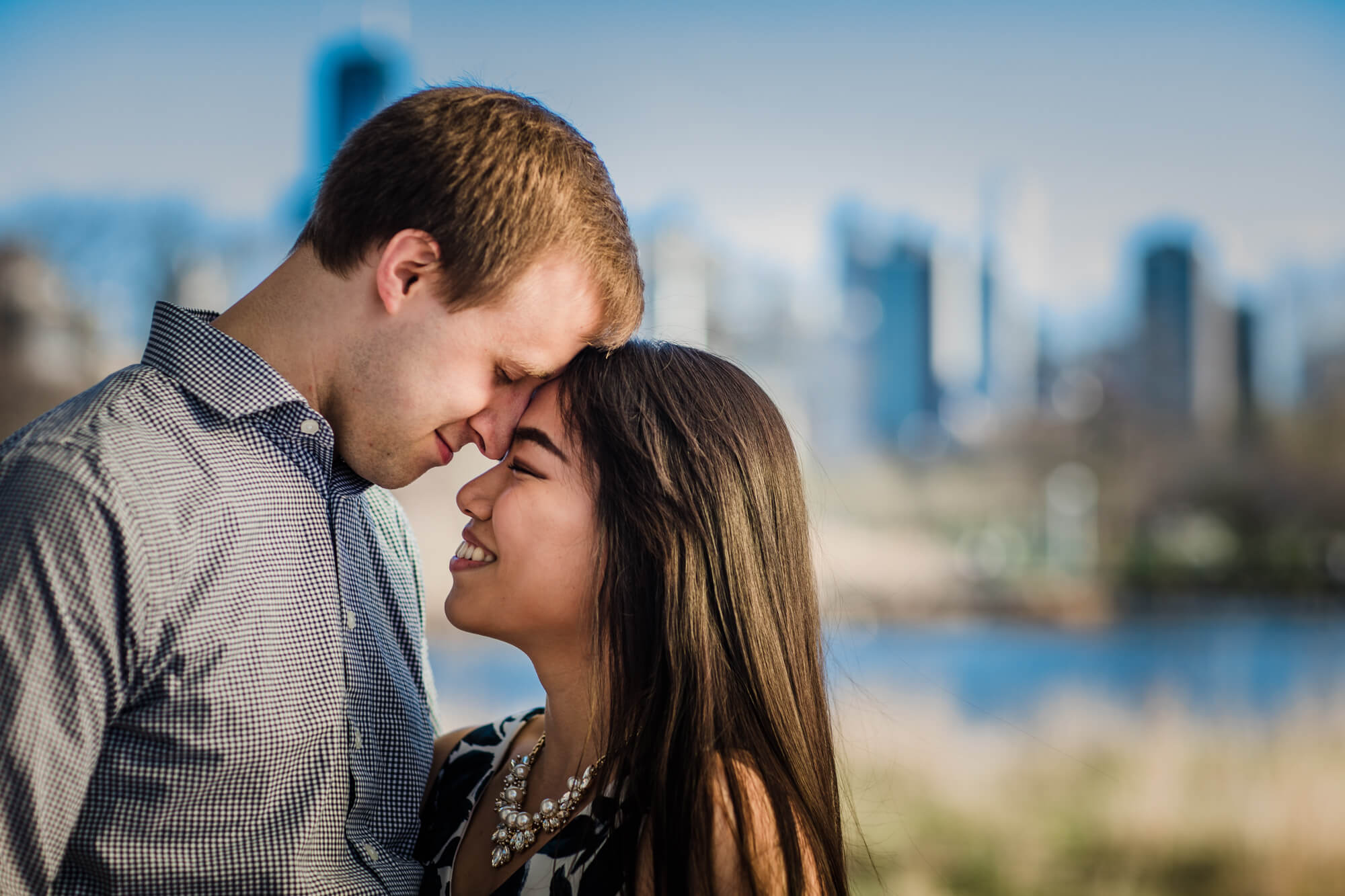 Couple touch foreheads during Lincoln Park engagement shoot