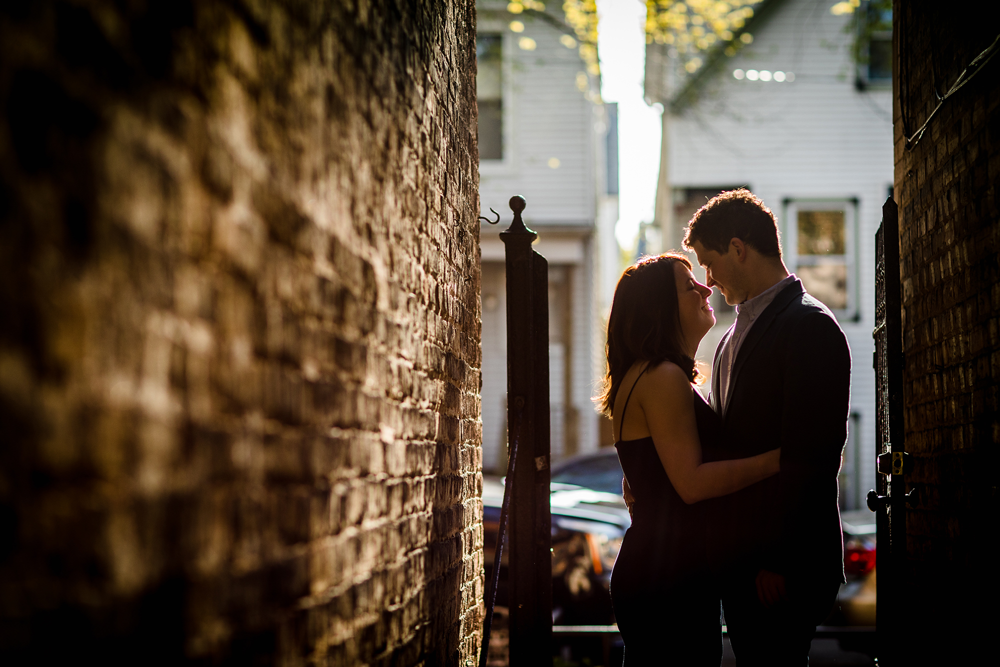 A couple hugs each other in the sunset during a Roscoe Village engagement session. 