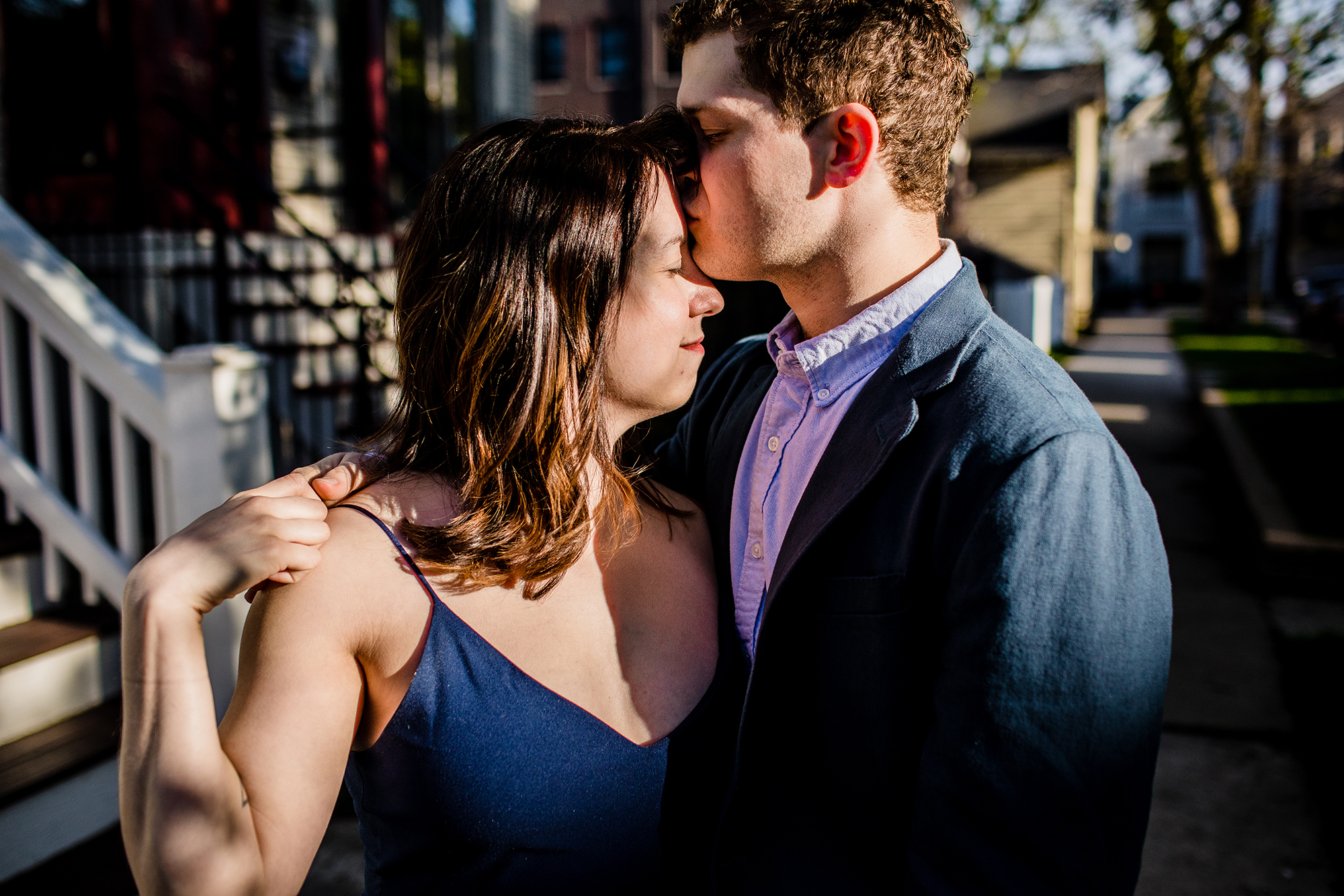 A couples kisses in the sunlight during a Roscoe Village engagement session.