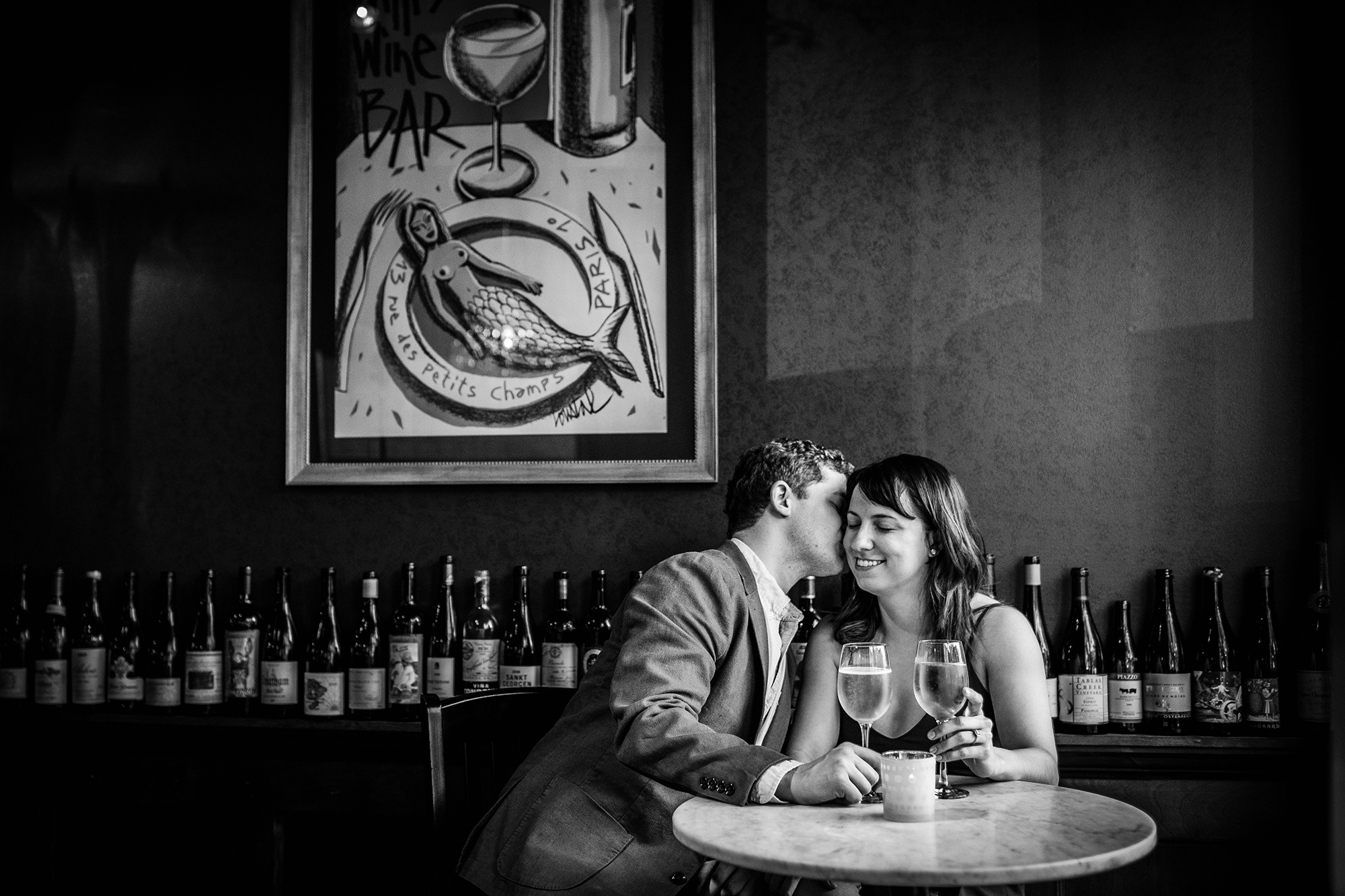 A couple shares a drink together during a Roscoe Village engagement session. 