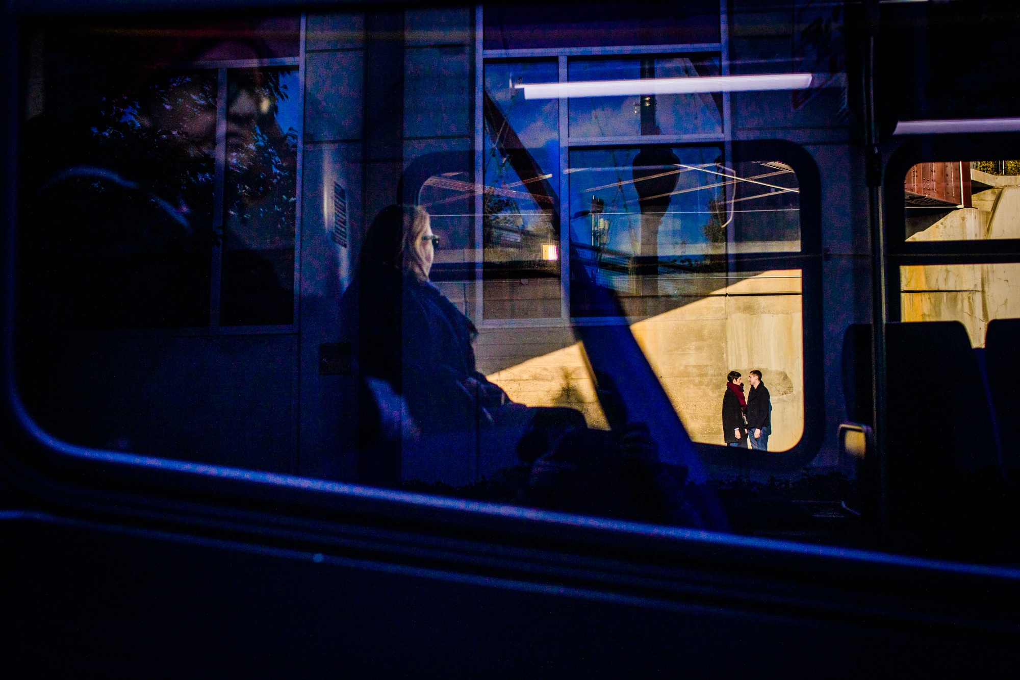A couple framed in a bus window during a Wicker Park engagement session