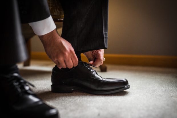 A groom gets ready before his backyard wedding in Yorkville, Illinois