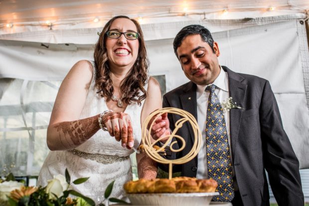 A couple cuts their cake at a backyard wedding in Yorkville, Illinois