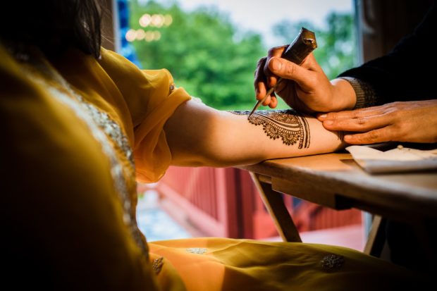 A bride has henna done by Unnati Shah