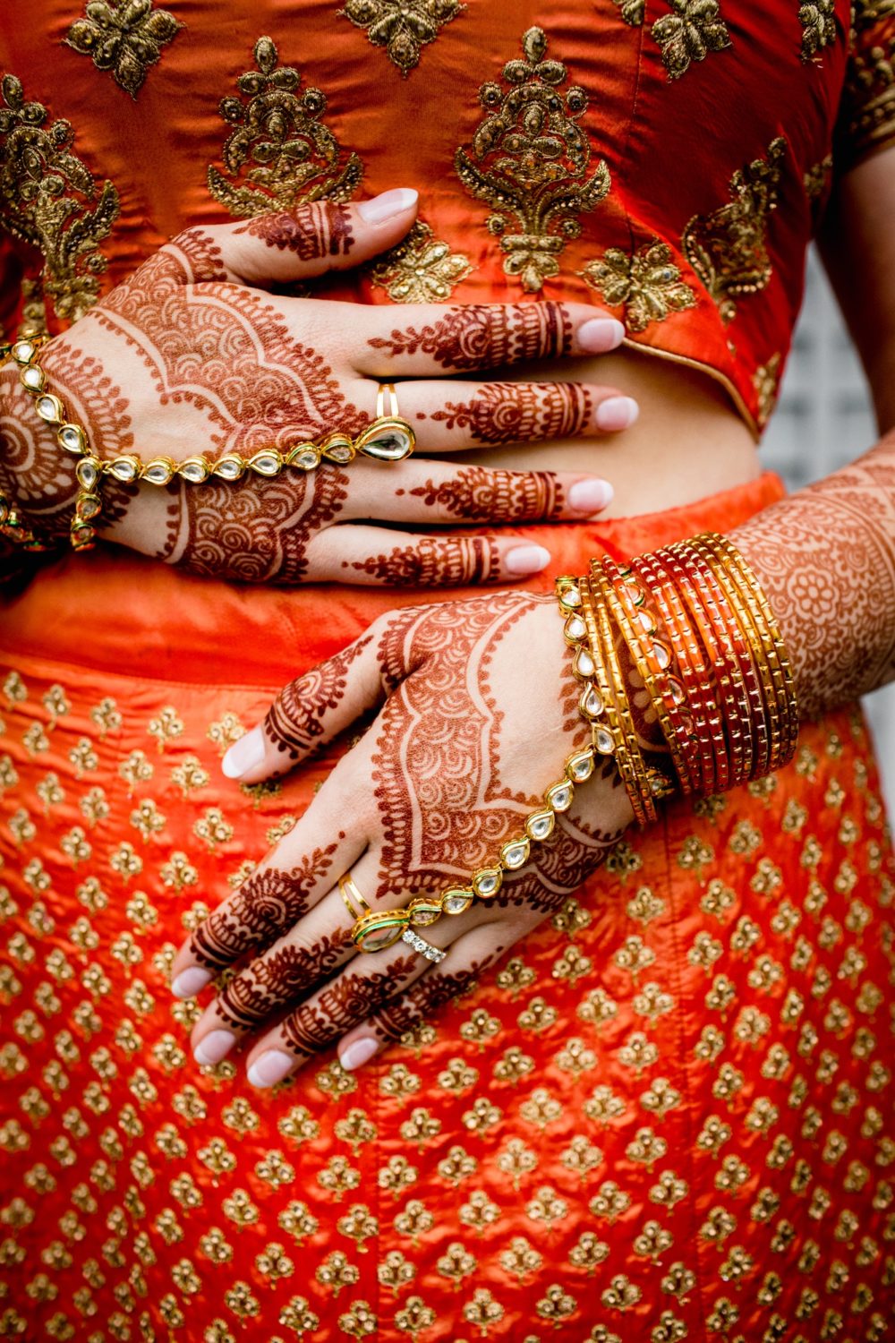 A brides hand covered in henna before an Aurora Balaji Temple wedding