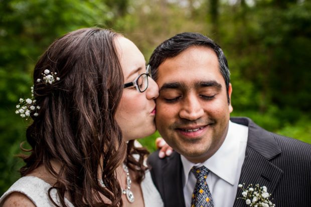 A bride kisses her groom at a backyard wedding in Yorkville, Illinois