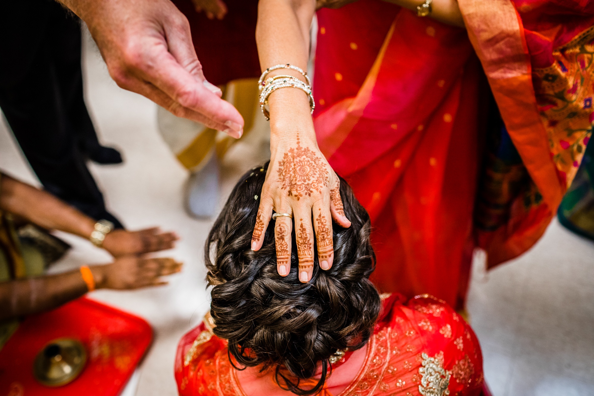 A bride has her head blessed during an Aurora Balaji Temple wedding