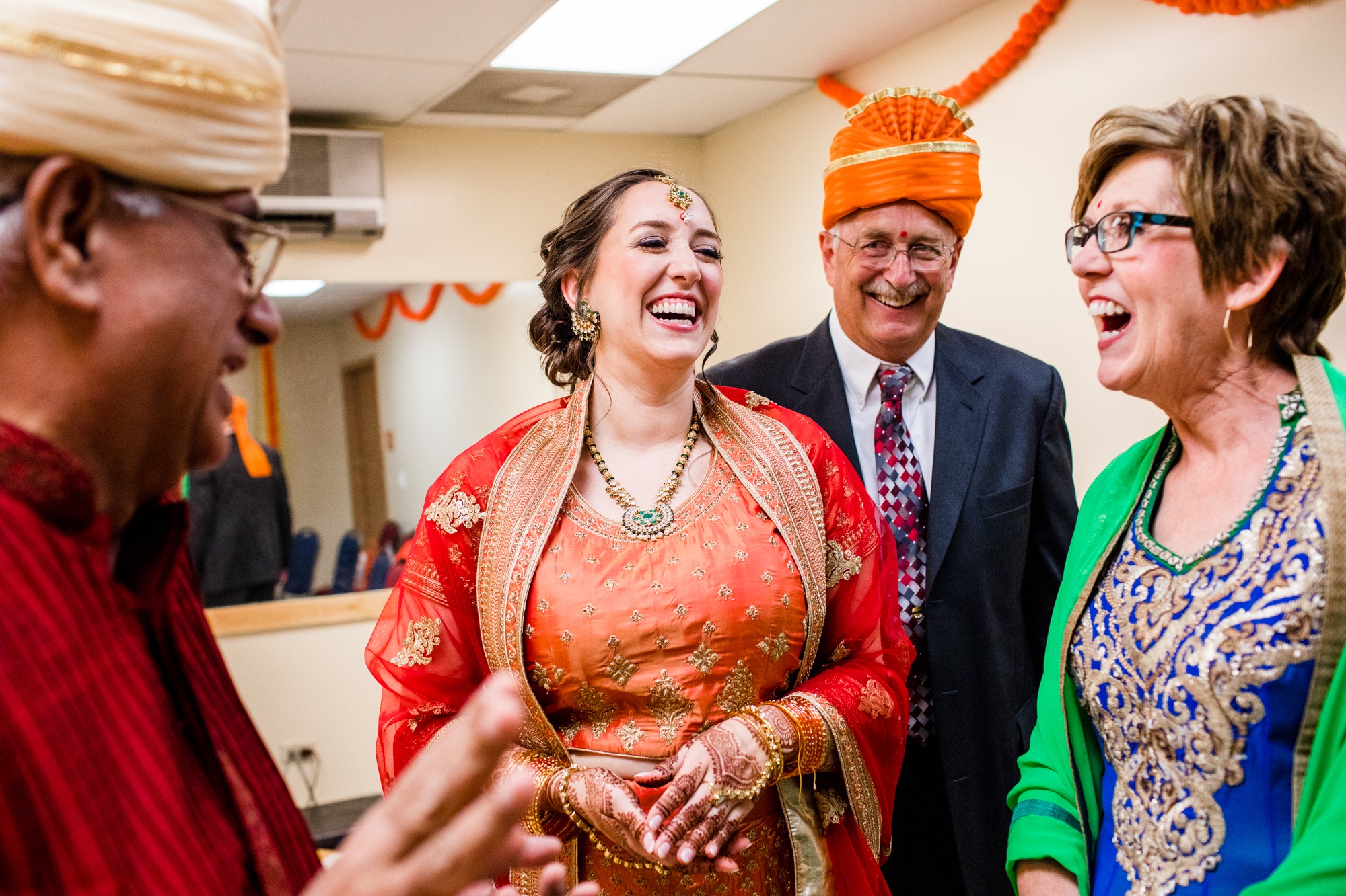 A bride laughs with her family during an Aurora Balaji Temple wedding