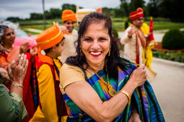 Guests dance at a baraat during an Aurora Balaji Temple wedding ceremony