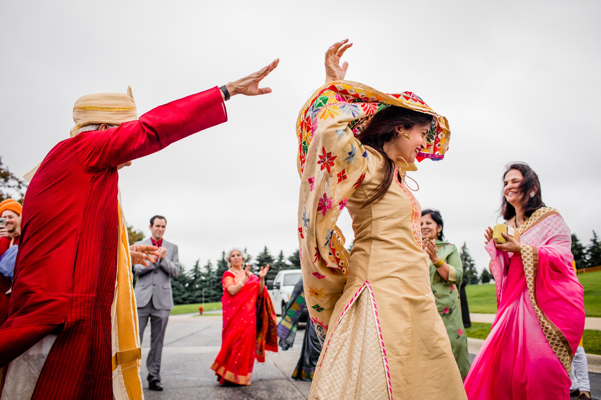 Guests dance at a baraat during an Aurora Balaji Temple wedding ceremony