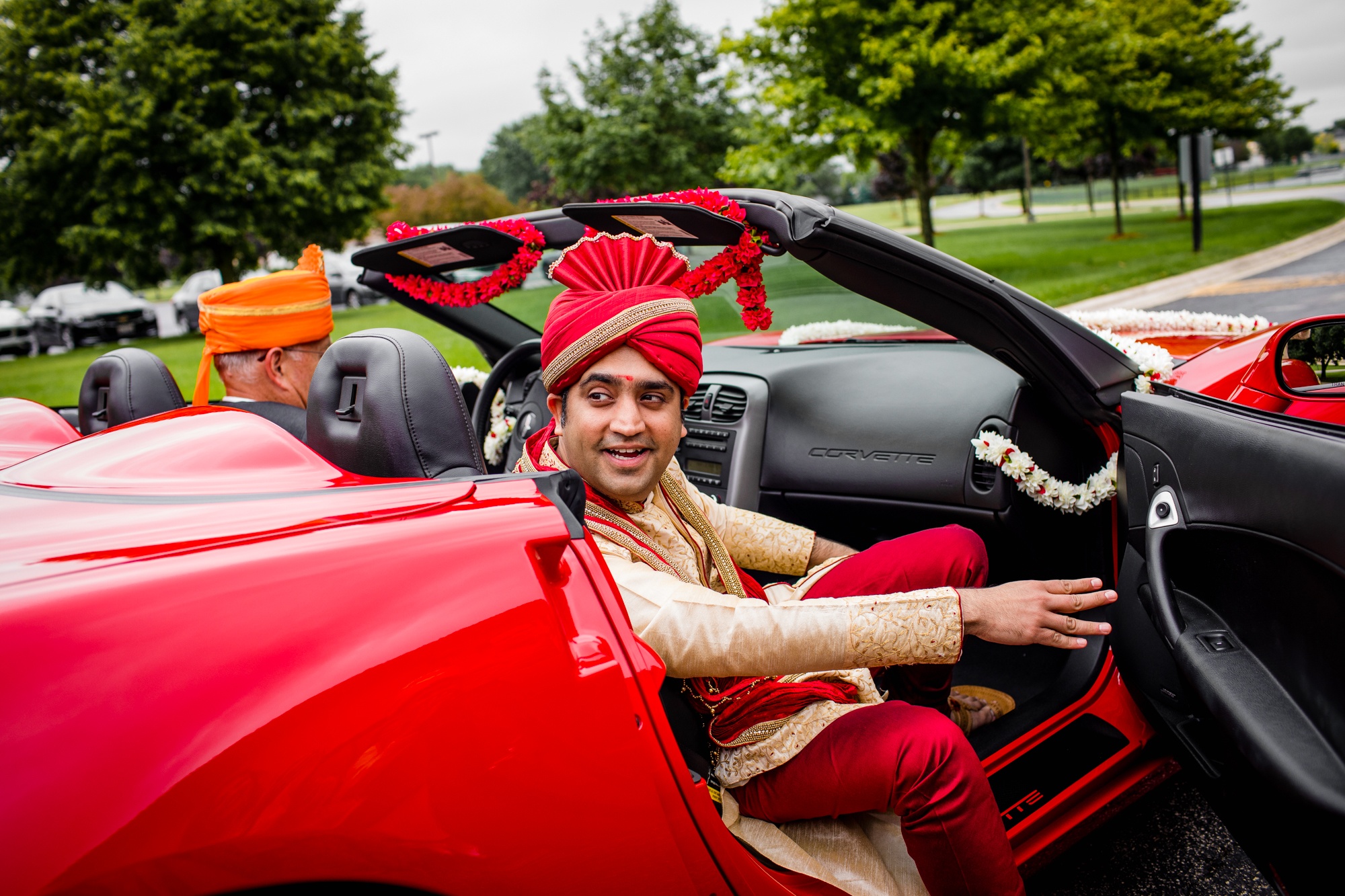 A groom leaves his car at a baraat during an Aurora Balaji Temple wedding ceremony