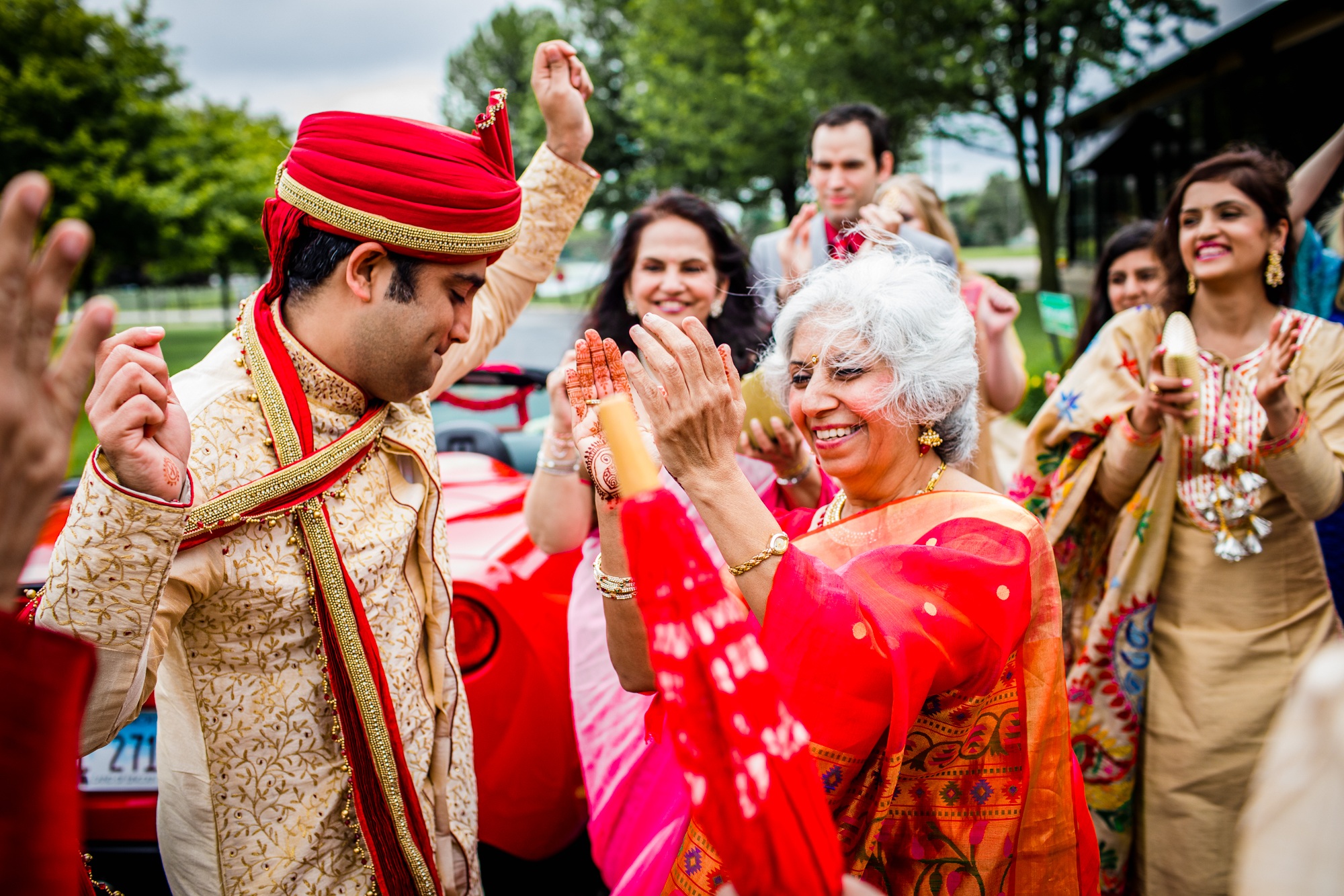 A groom dances with guests at a baraat during an Aurora Balaji Temple wedding ceremony
