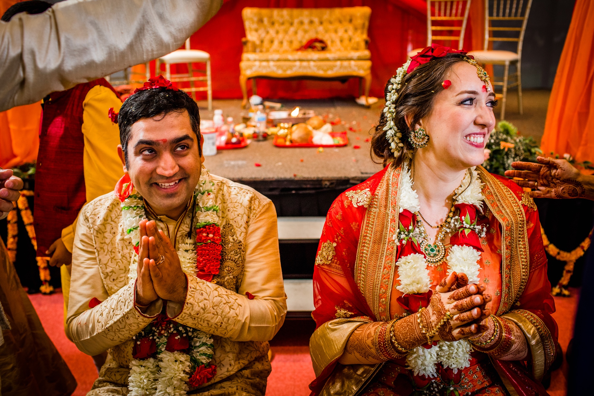 Guests throw rice on a couple during an Aurora Balaji Temple wedding