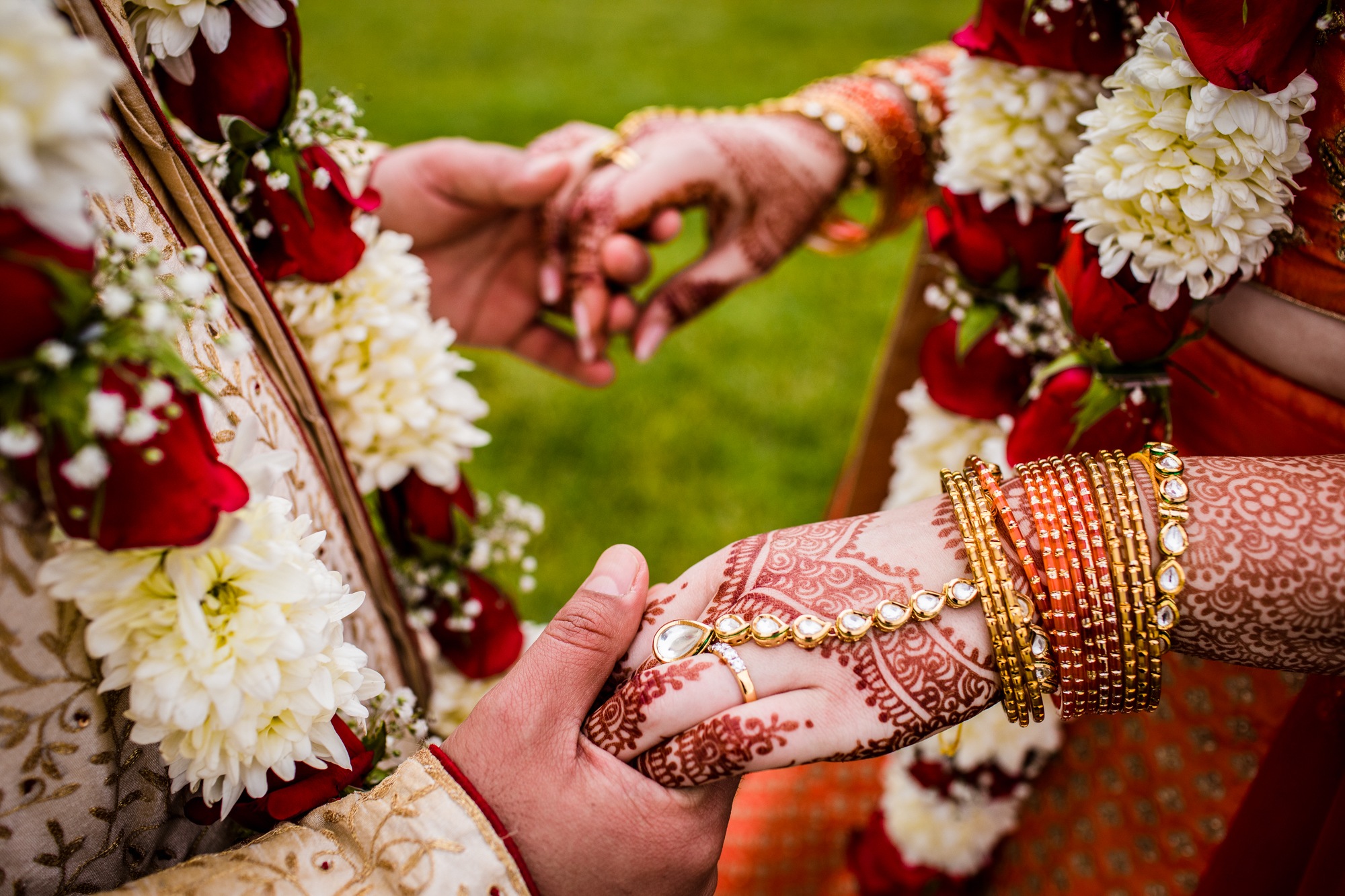 A close-up of a couple's hands at Aurora Balaji Temple