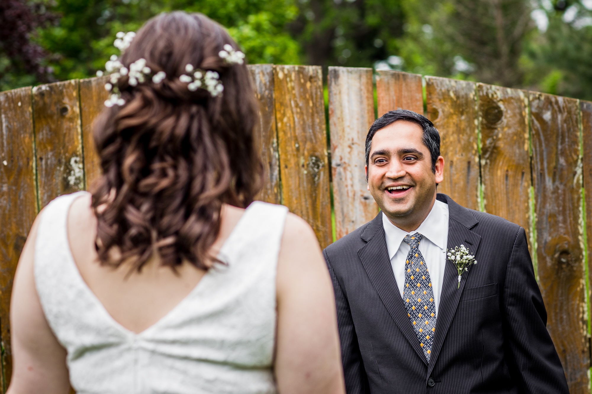 A groom shares a first look with his bride at a backyard wedding in Yorkville, Illinois