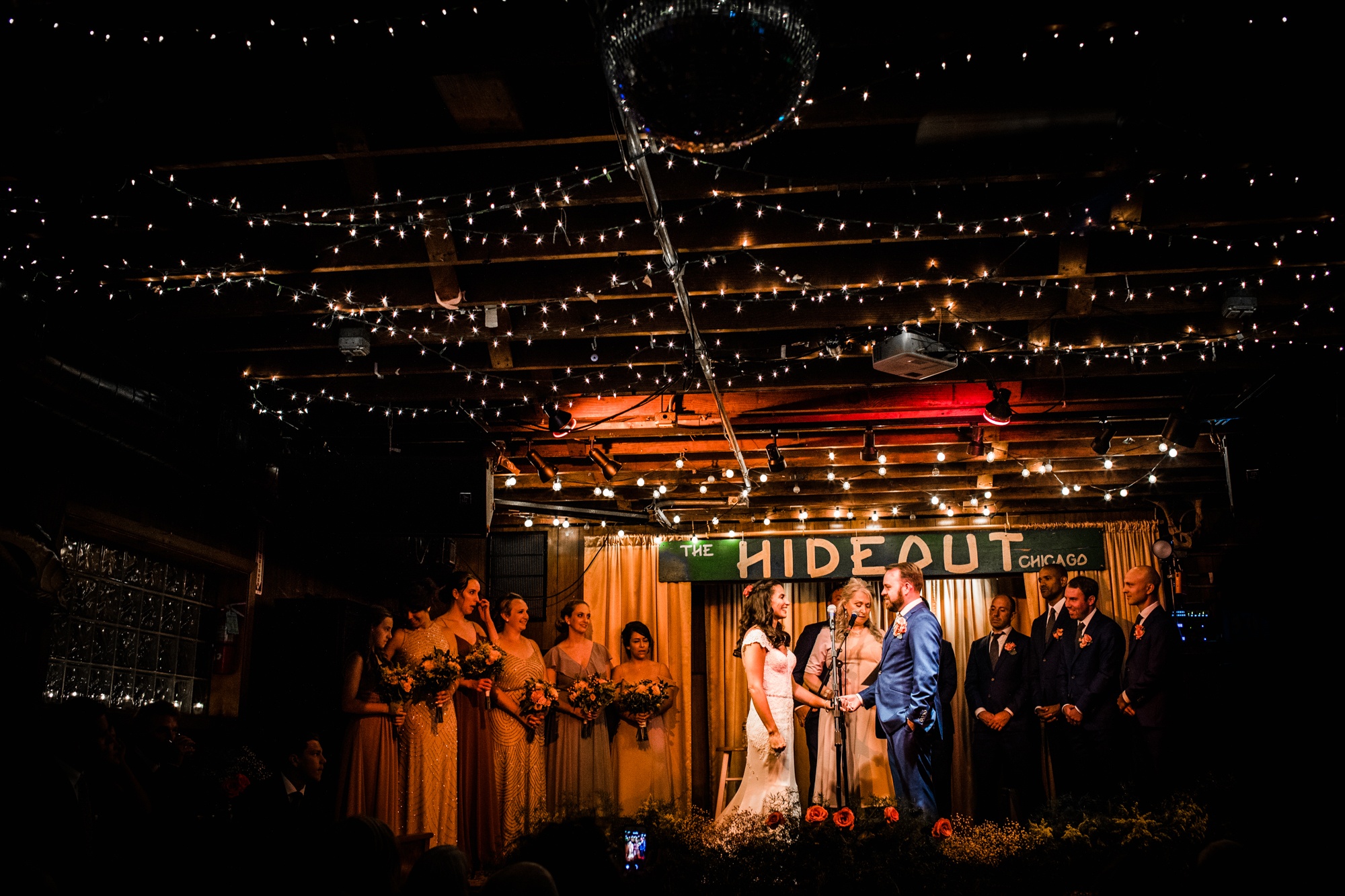 A couple holds hands during a Hideout Chicago wedding ceremony