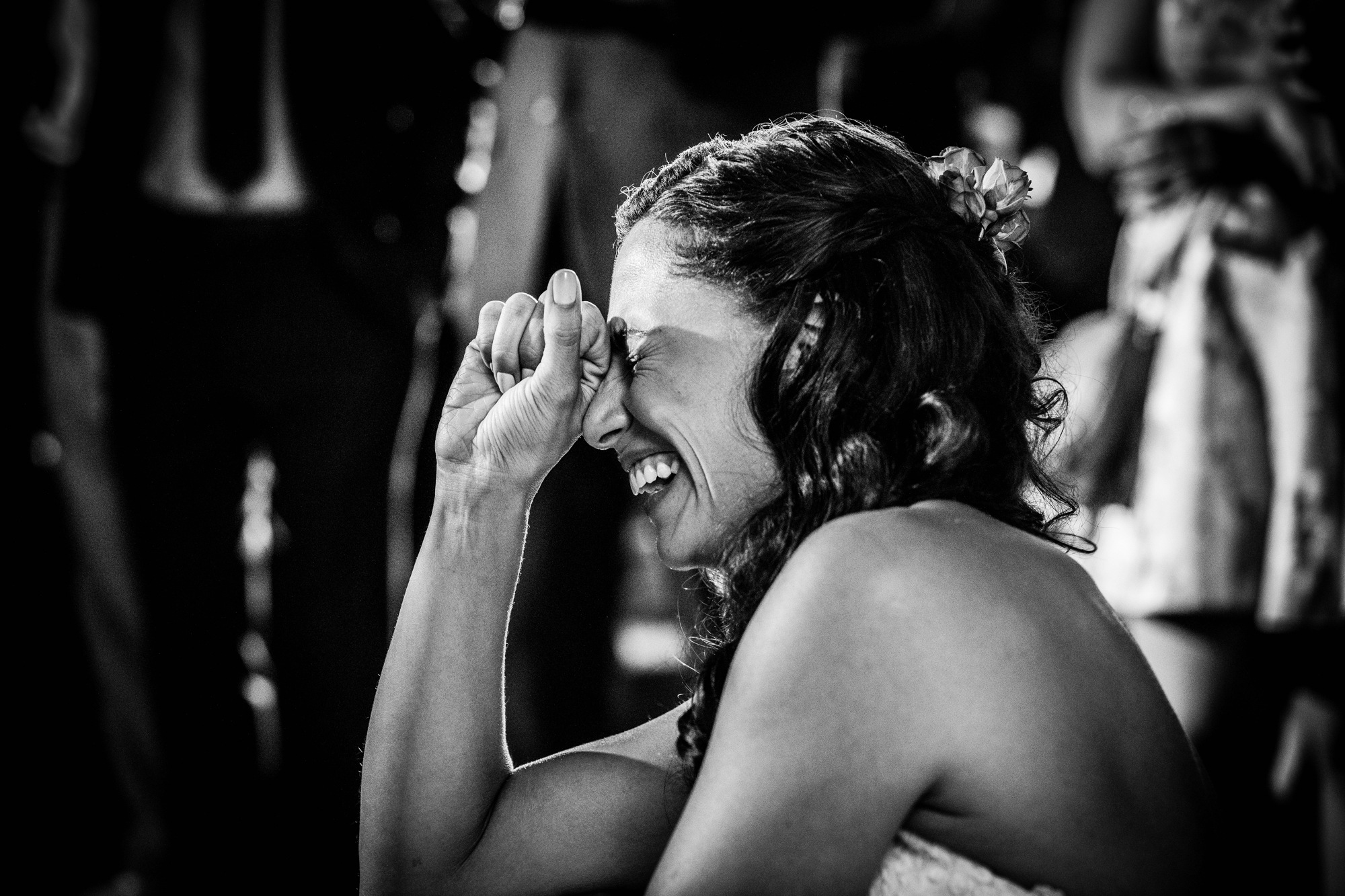 A bride laughs at a toast during a Hideout Chicago wedding reception