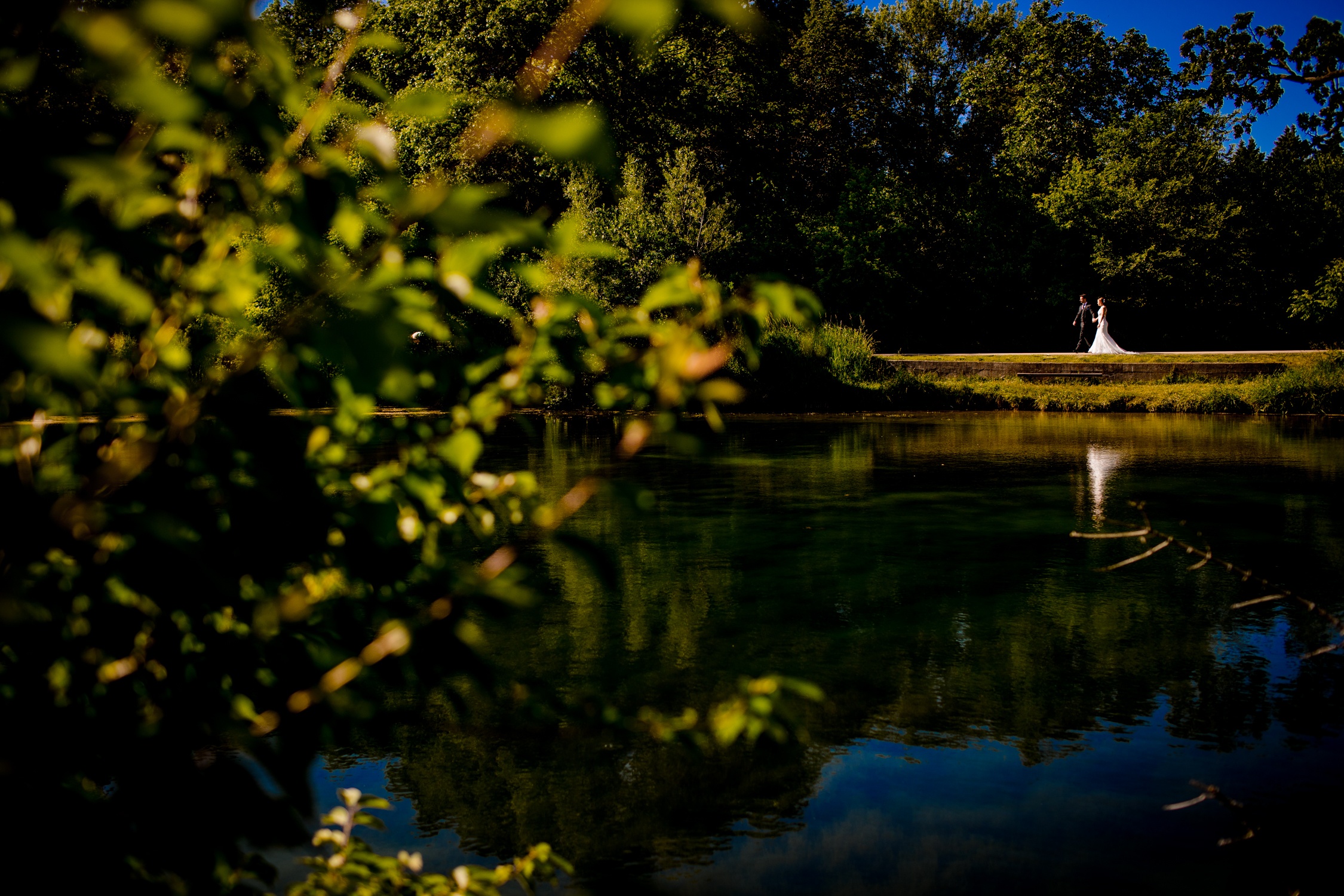 A couple walks along a path at DuPage River Park during their Naperville Micro wedding.