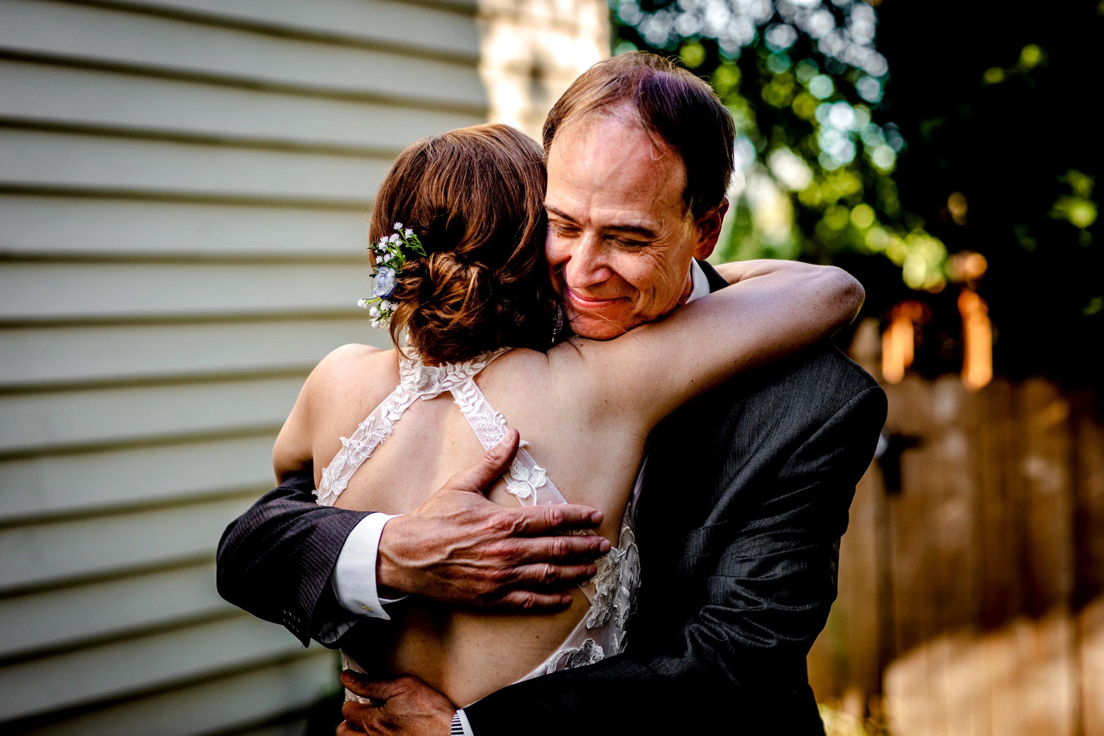 A father hugs his daughter during a first look at her Naperville micro wedding.