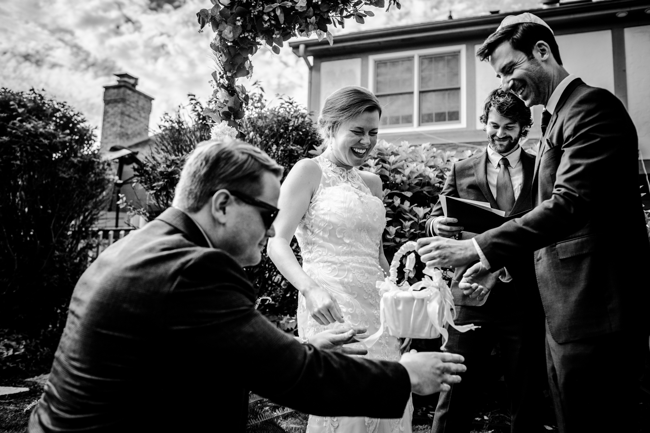 A couple laughs as their friend delivers the rings during a Naperville micro wedding.