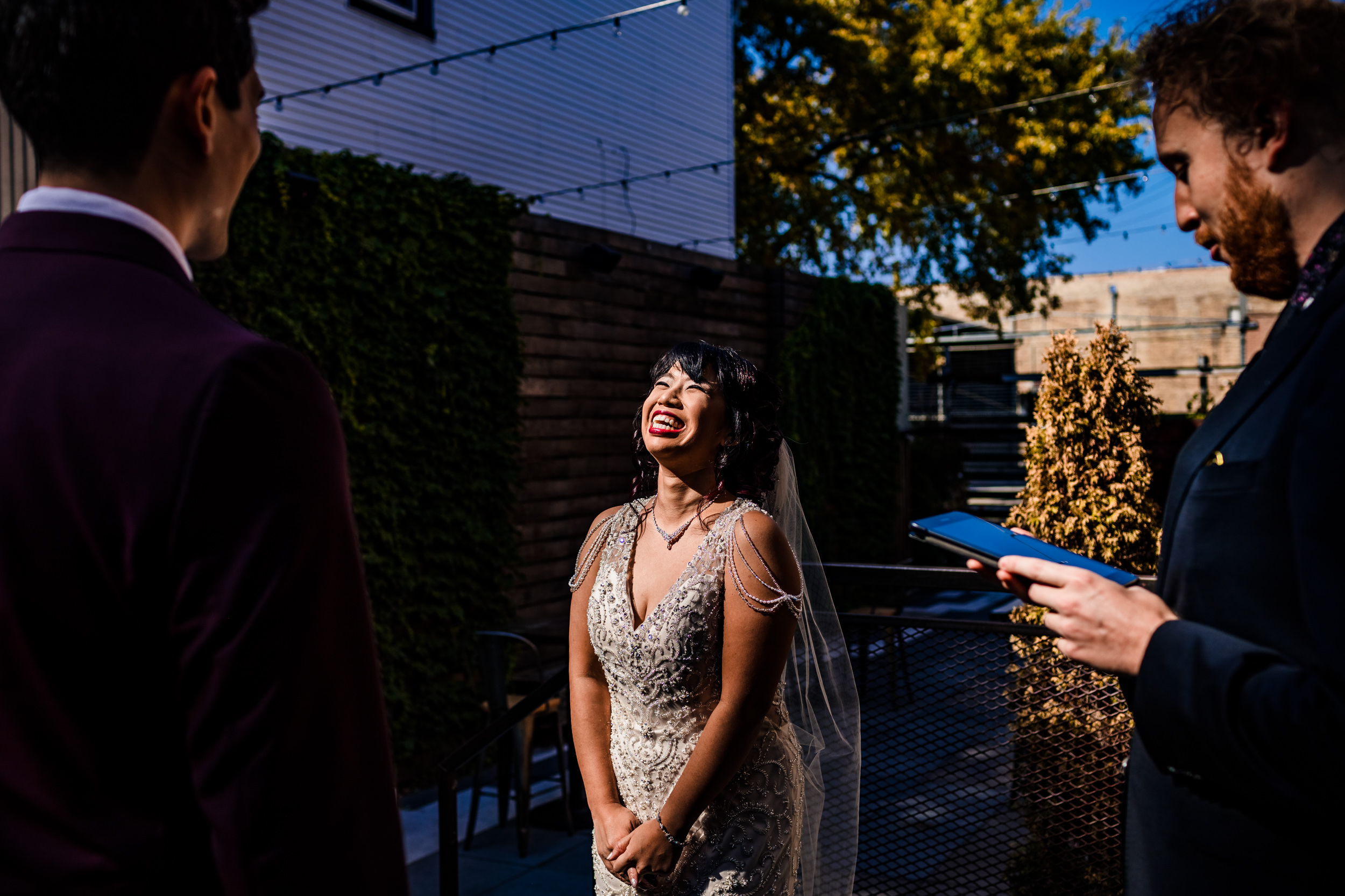A bride laughs during her wedding ceremony at the Joinery.