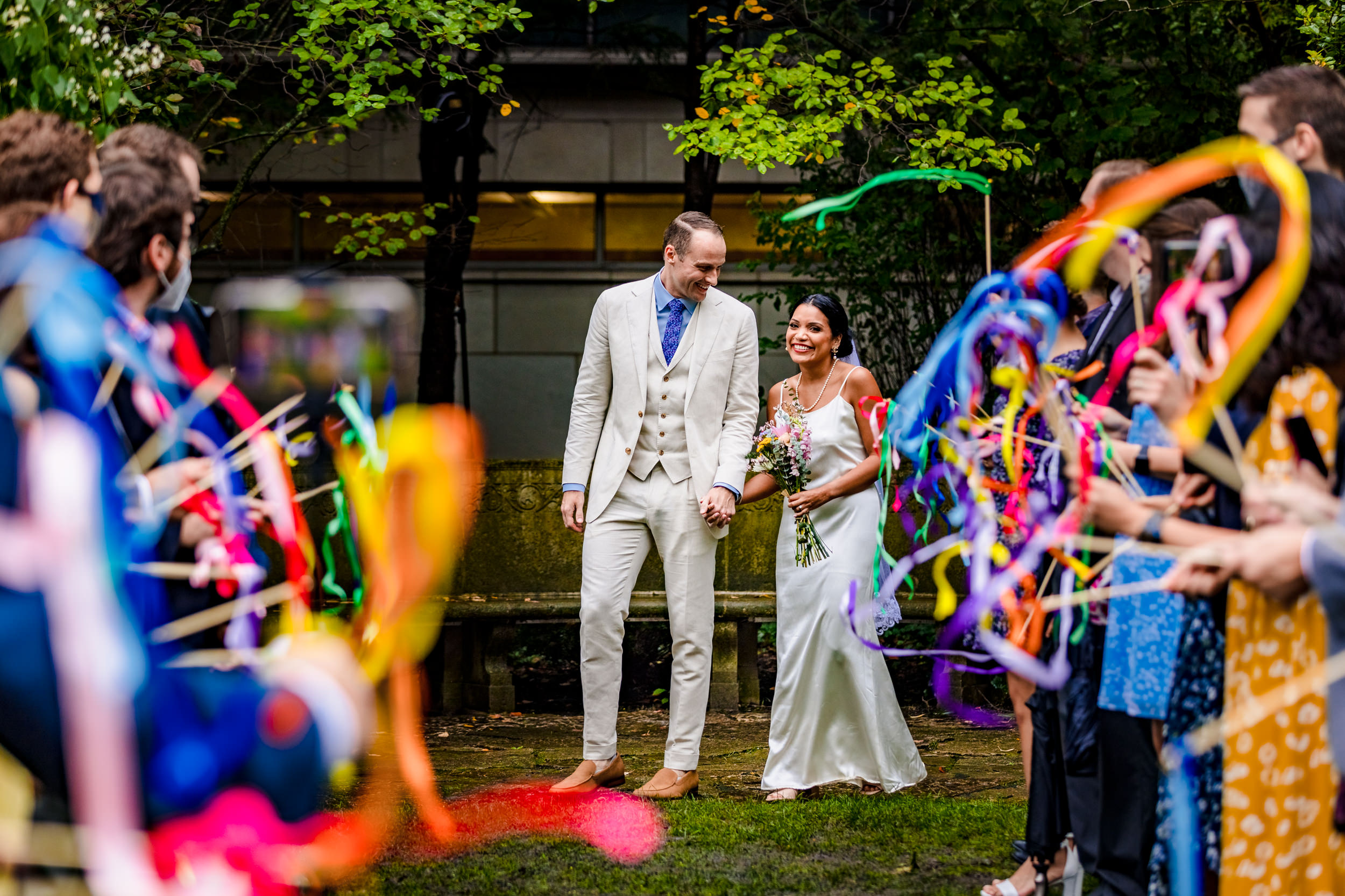 A couple walks down the aisle during a Shakespeare Garden micro wedding in Evanston.