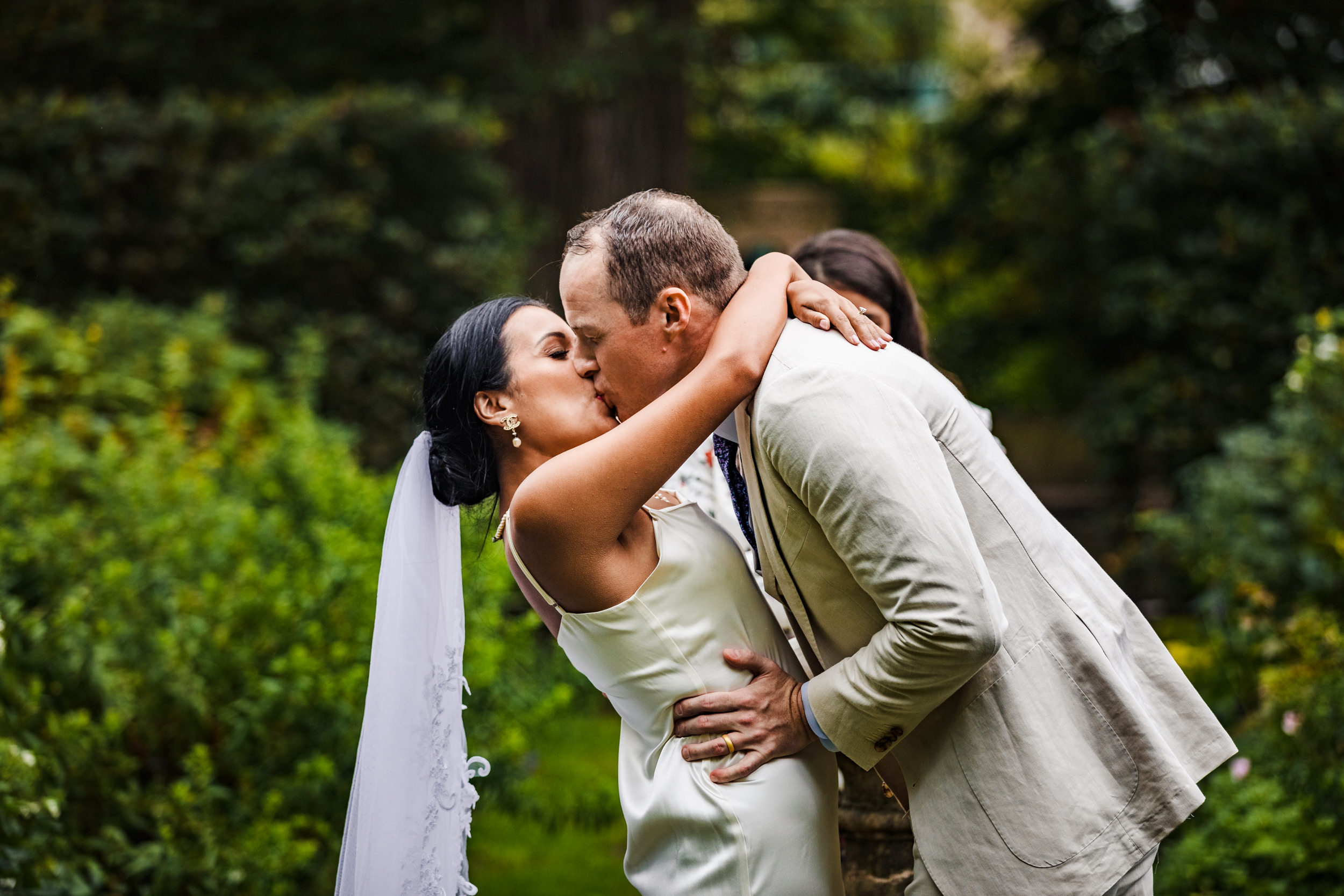 A couple shares their first kiss together during a Shakespeare Garden micro wedding in Evanston.
