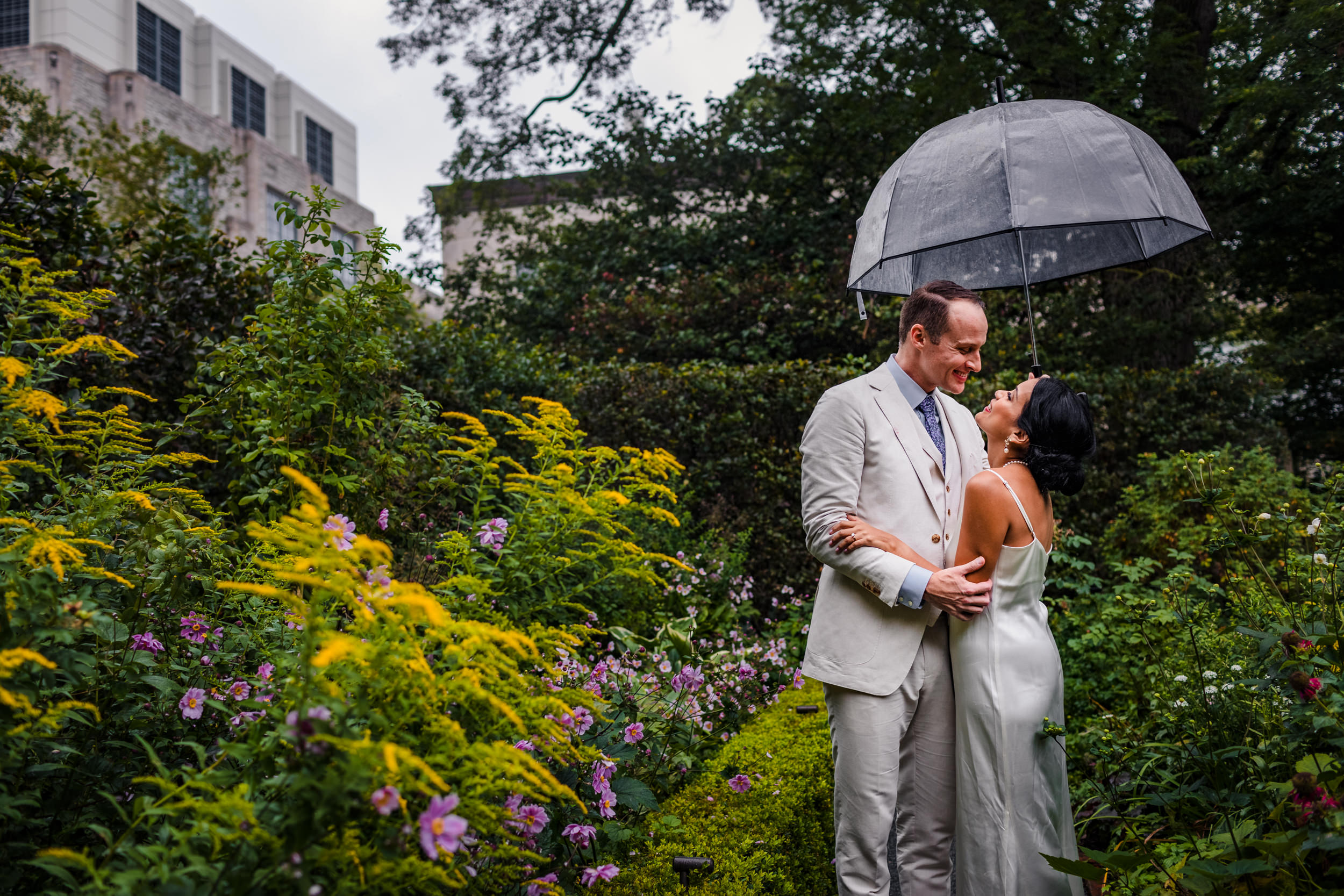 A couple laughs together during a Shakespeare Garden micro wedding in Evanston.