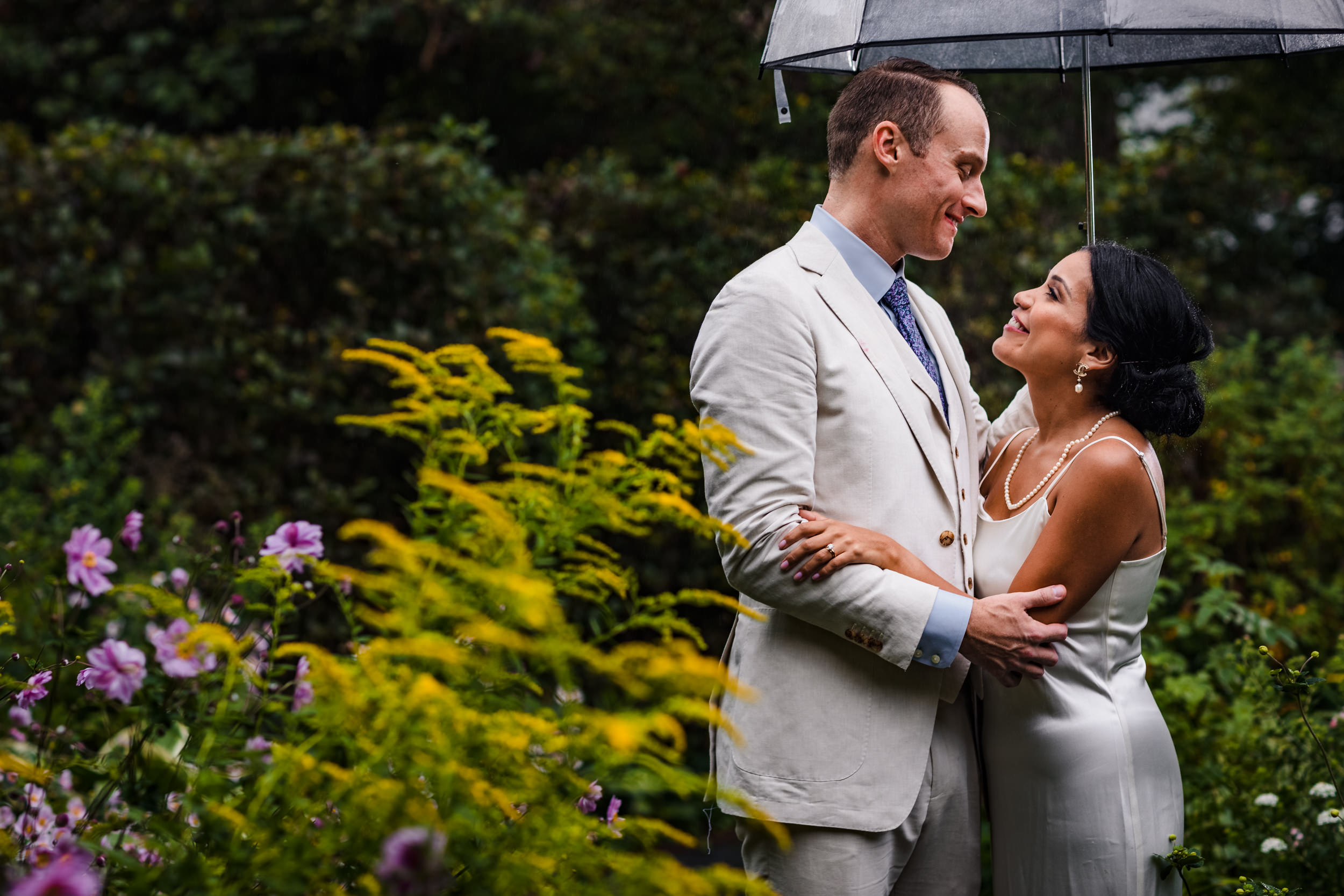 A couple laughs together during a Shakespeare Garden micro wedding in Evanston.
