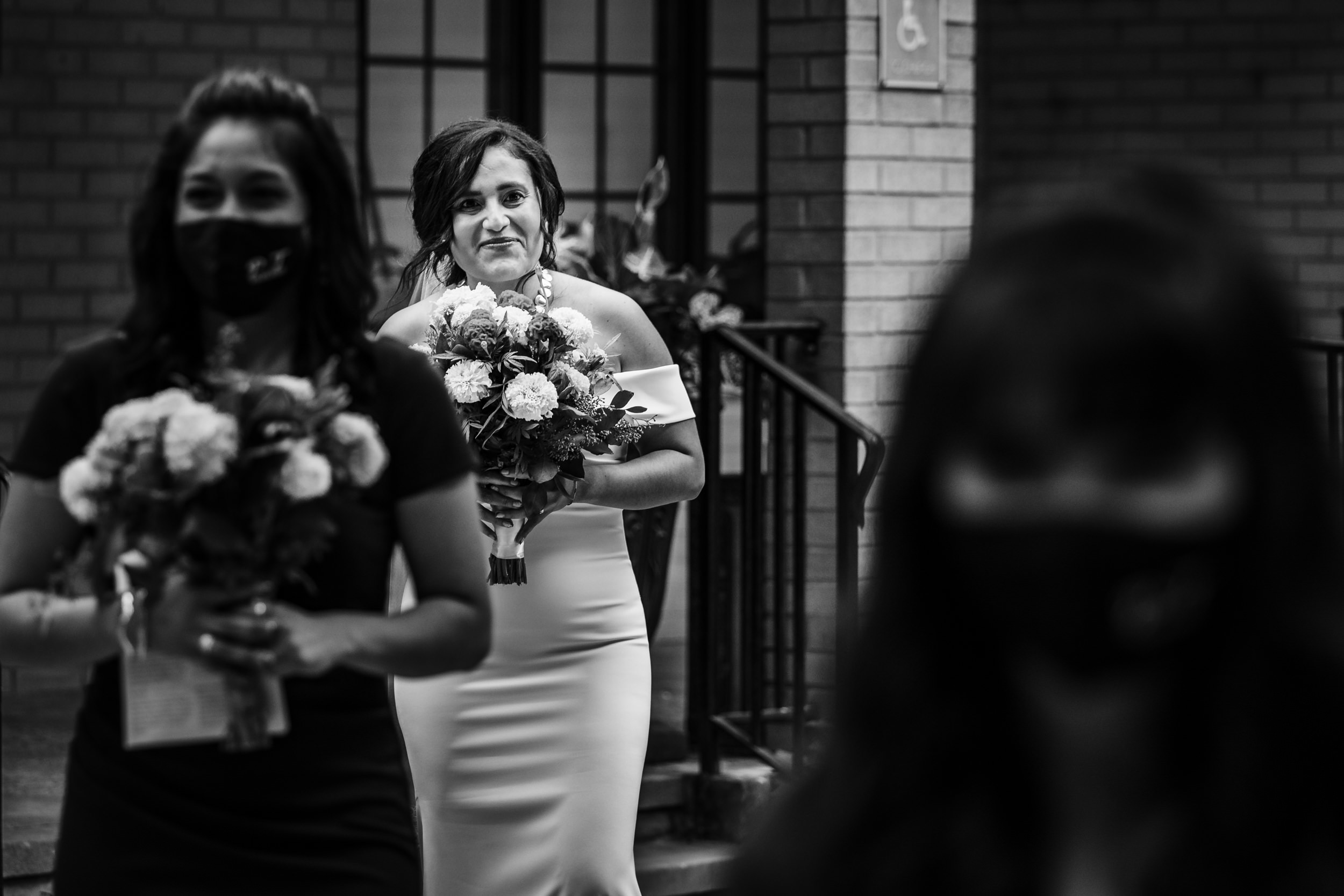 A bride walks down the aisle during her Church of the Ascension garden wedding in downtown Chicago.