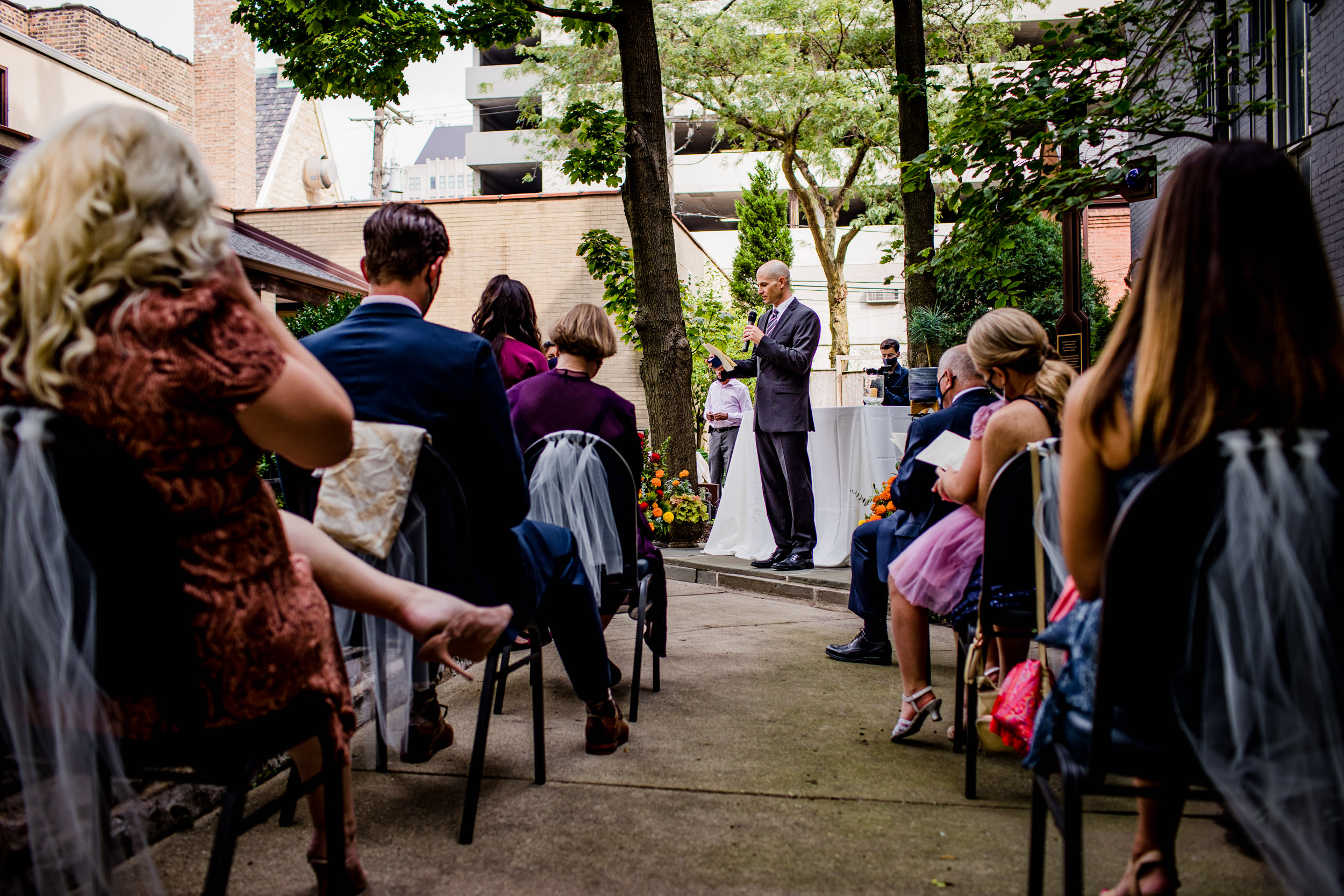 Guests listen to a reading during a Church of the Ascension garden wedding in downtown Chicago.