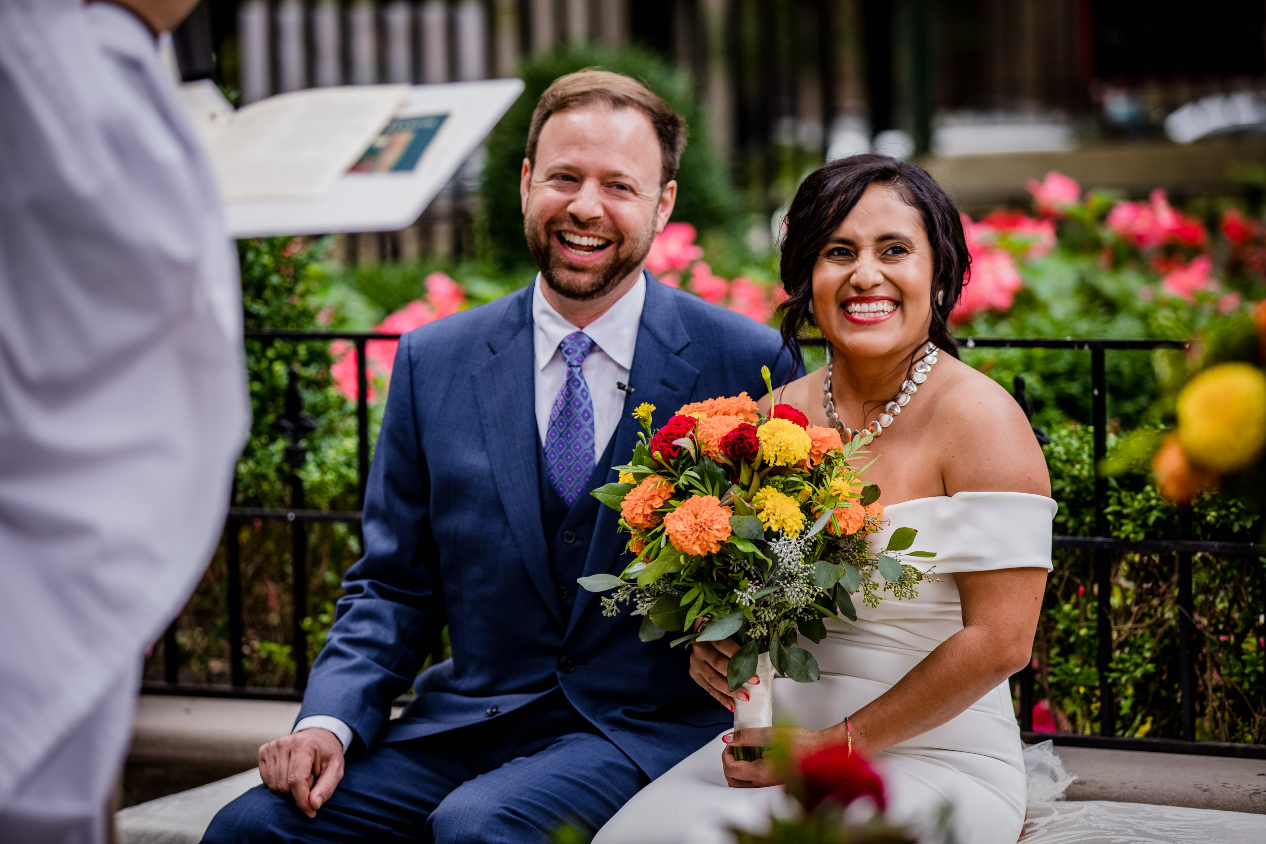 A couple laughs together during a Church of the Ascension garden wedding in downtown Chicago.