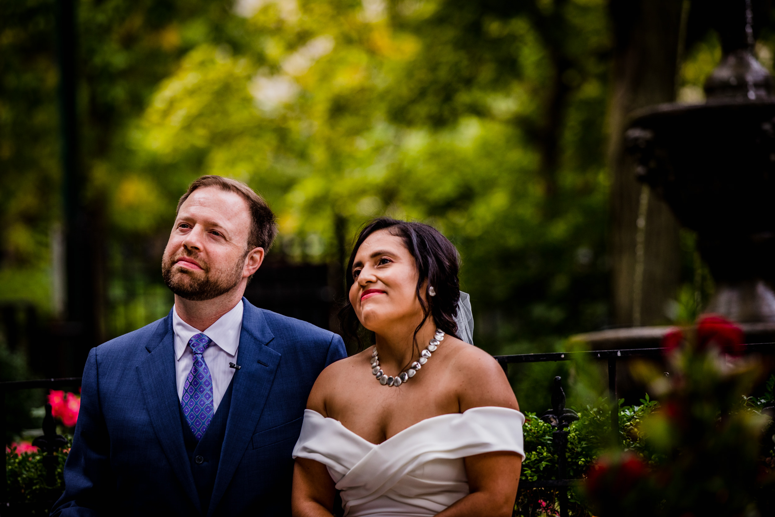 A couple smiles during a Church of the Ascension garden wedding ceremony in downtown Chicago.