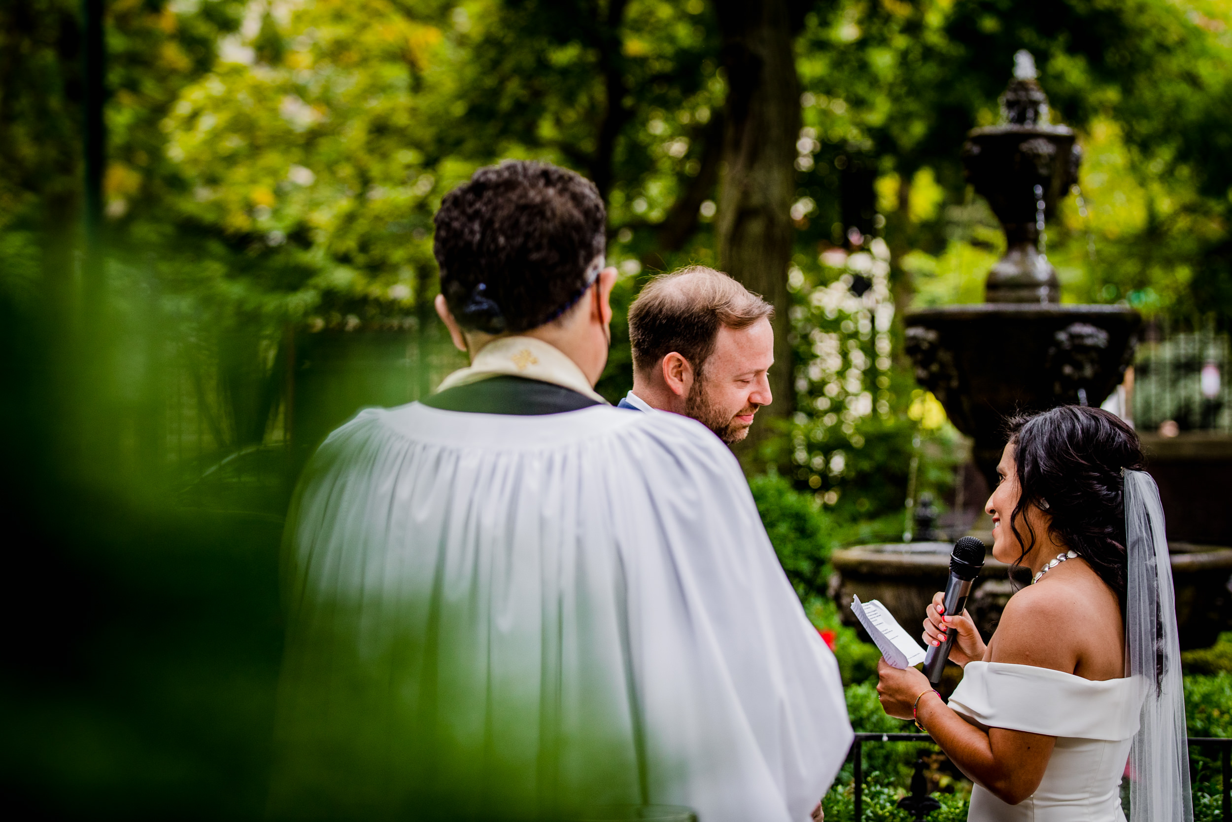 A couple shares their vows during a Church of the Ascension garden wedding ceremony in downtown Chicago.