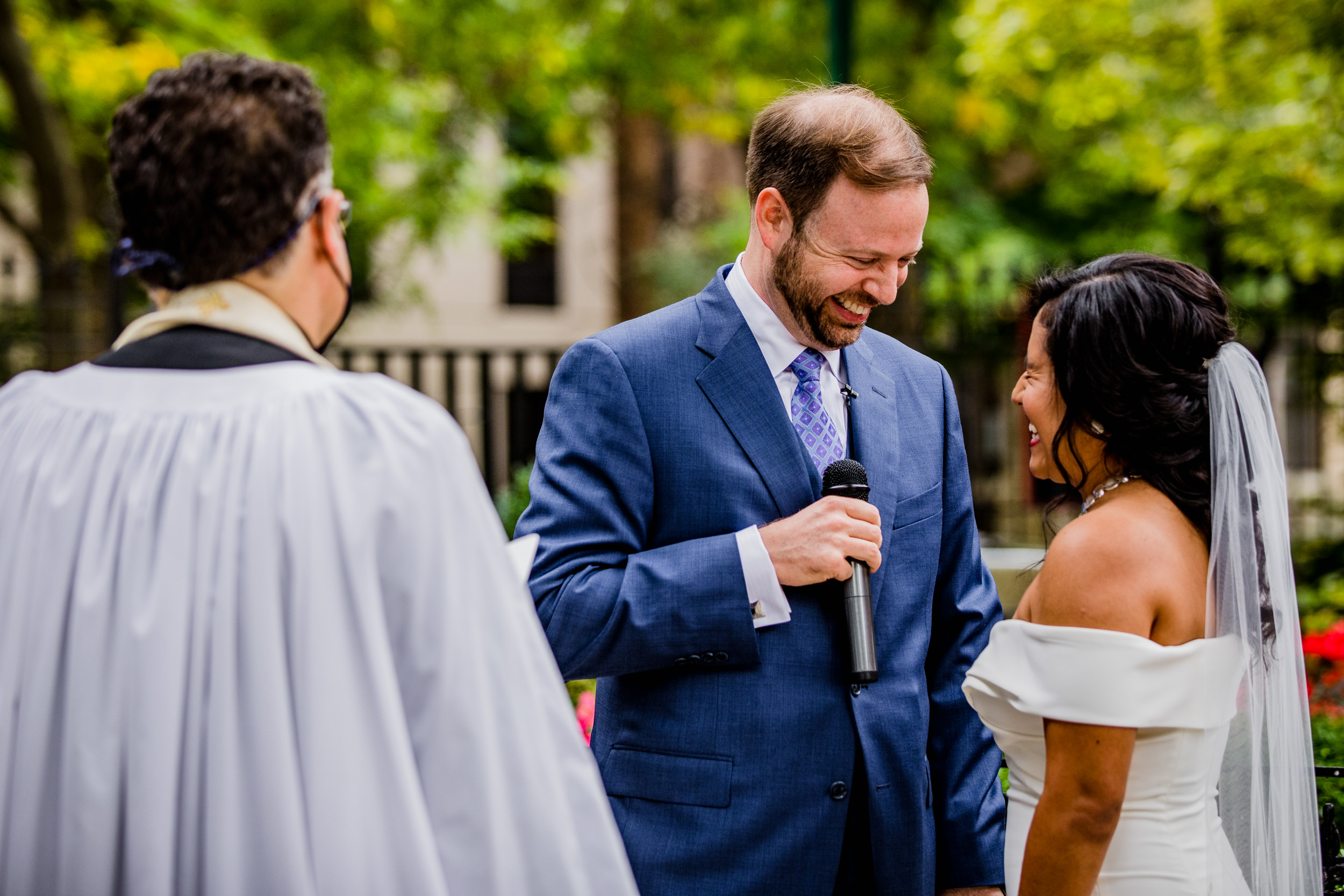 A couples laughs together during a Church of the Ascension garden wedding ceremony in downtown Chicago.