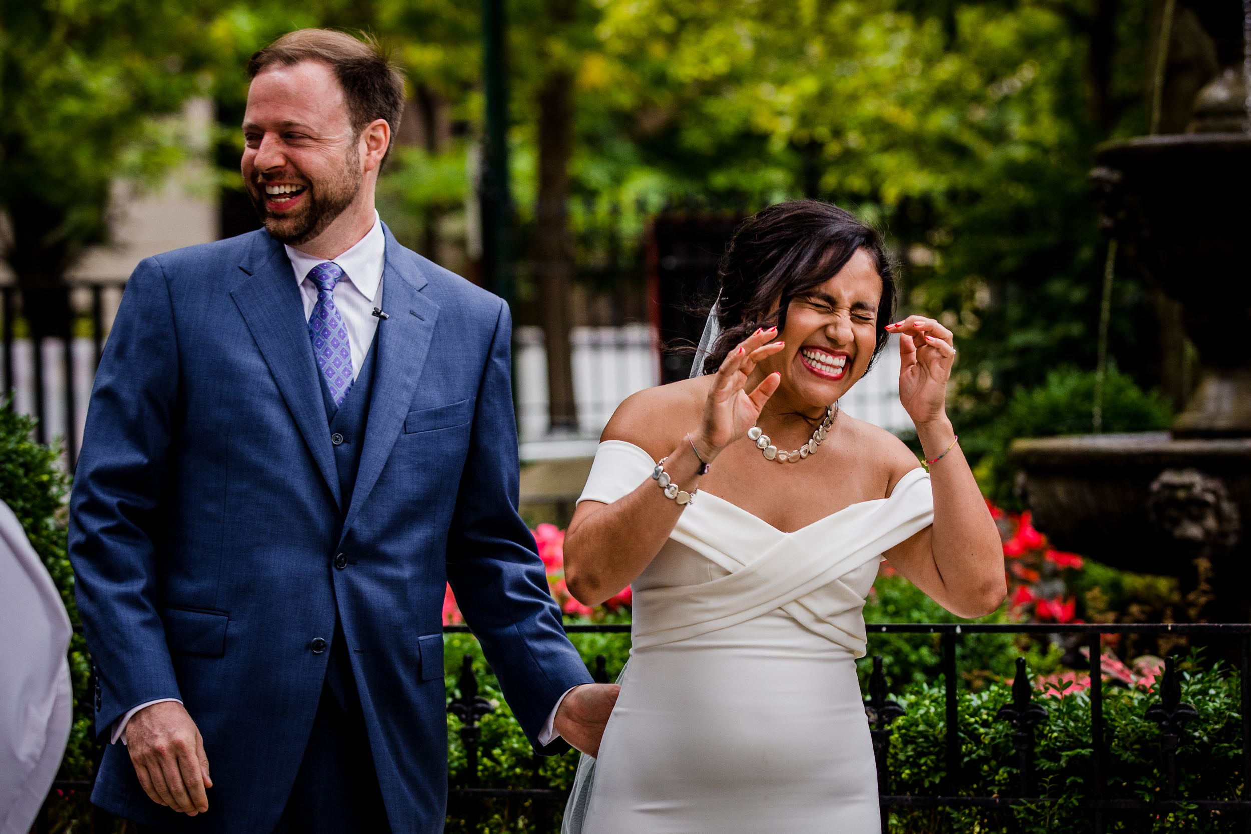 A bride and groom laugh together during a Church of the Ascension garden wedding ceremony in downtown Chicago.
