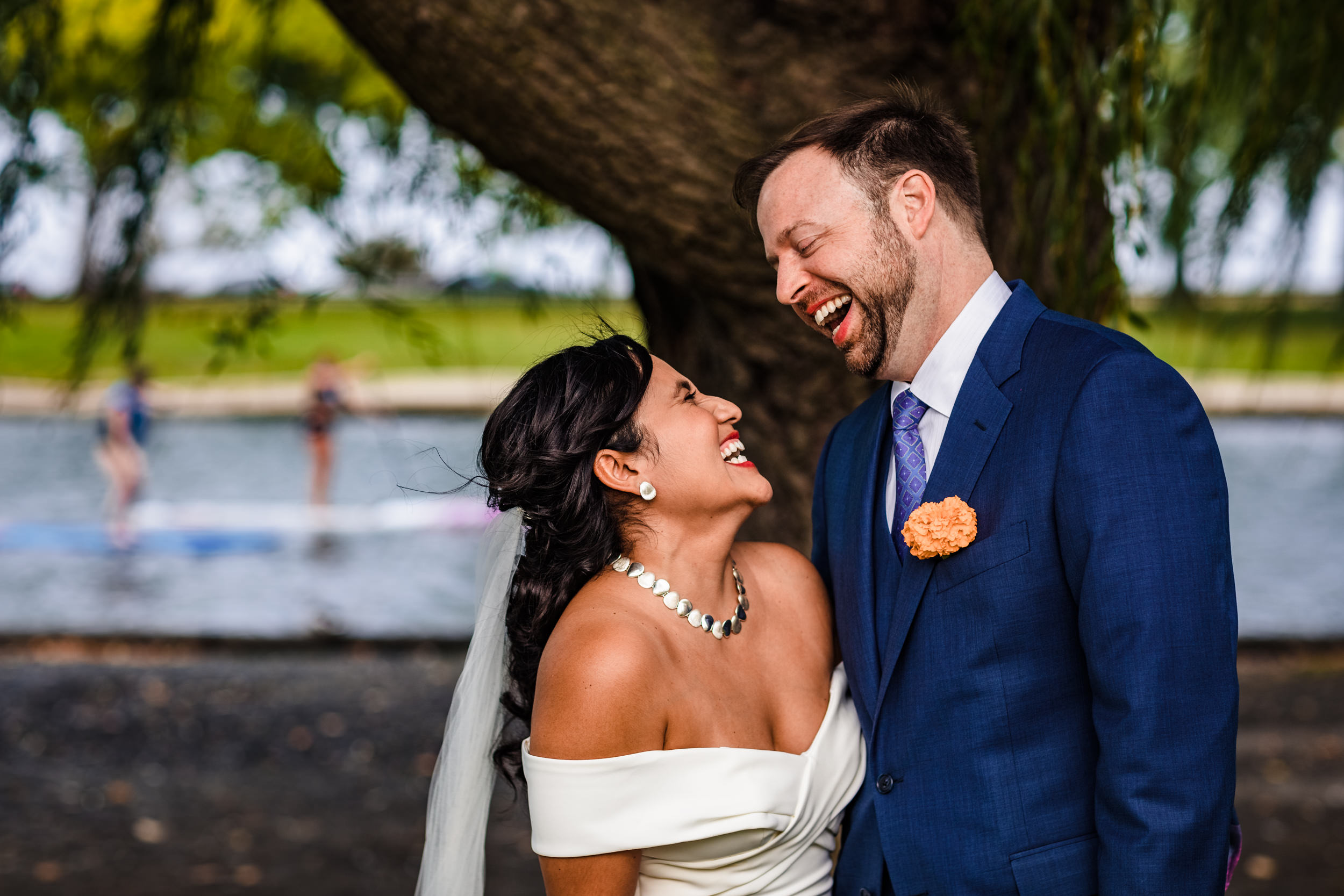 A couple laughs together while taking wedding portraits in Lincoln Park.