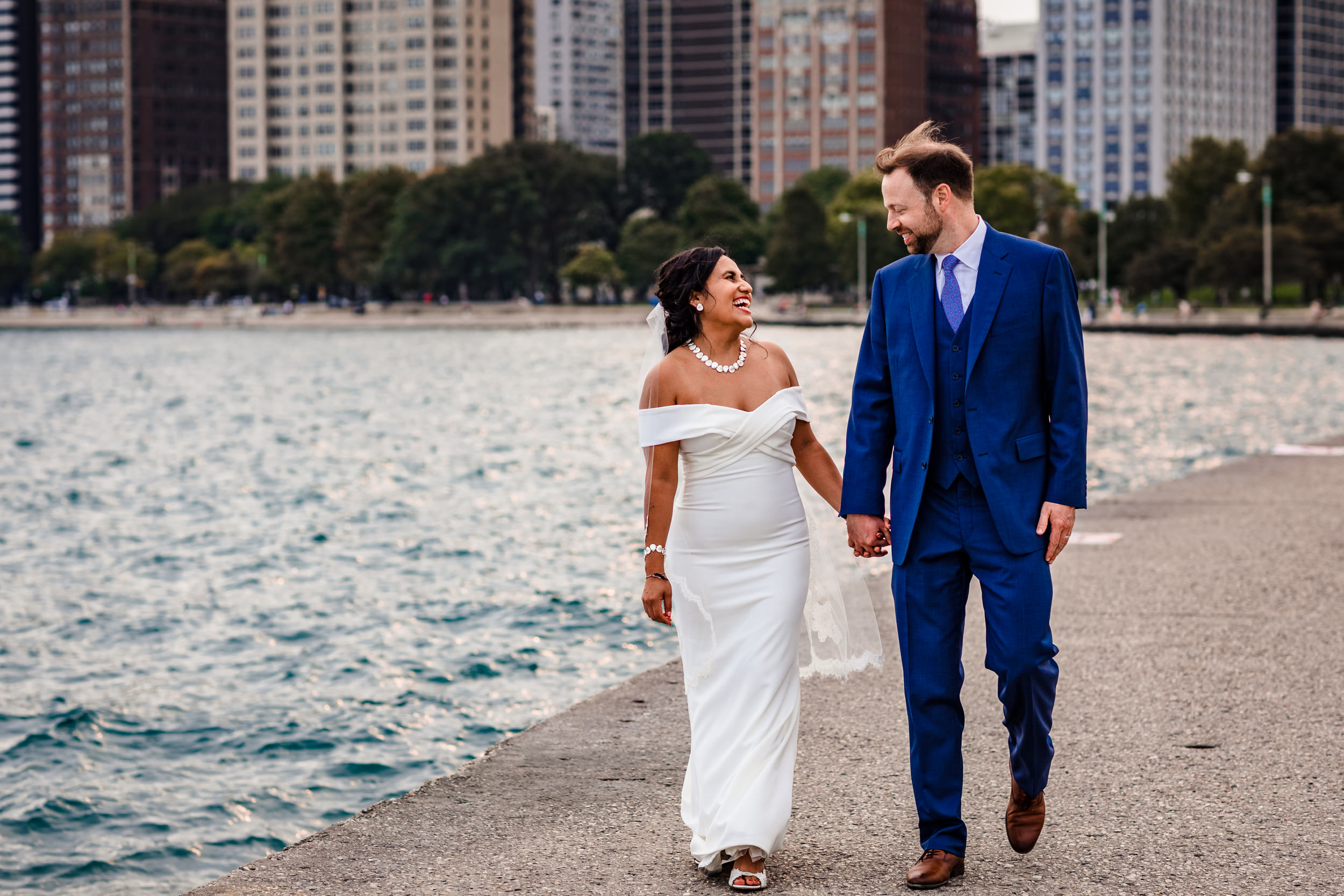 A couple laughs together while taking North Avenue Beach wedding photos.