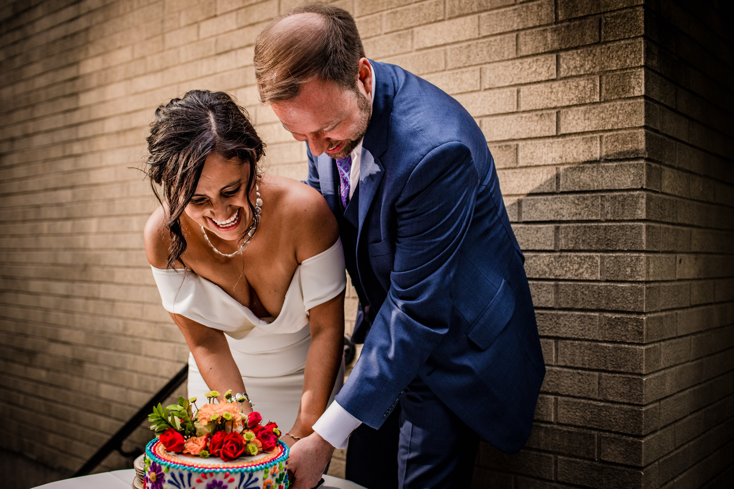 A couple cuts their cake during their Church of the Ascension garden wedding reception. 