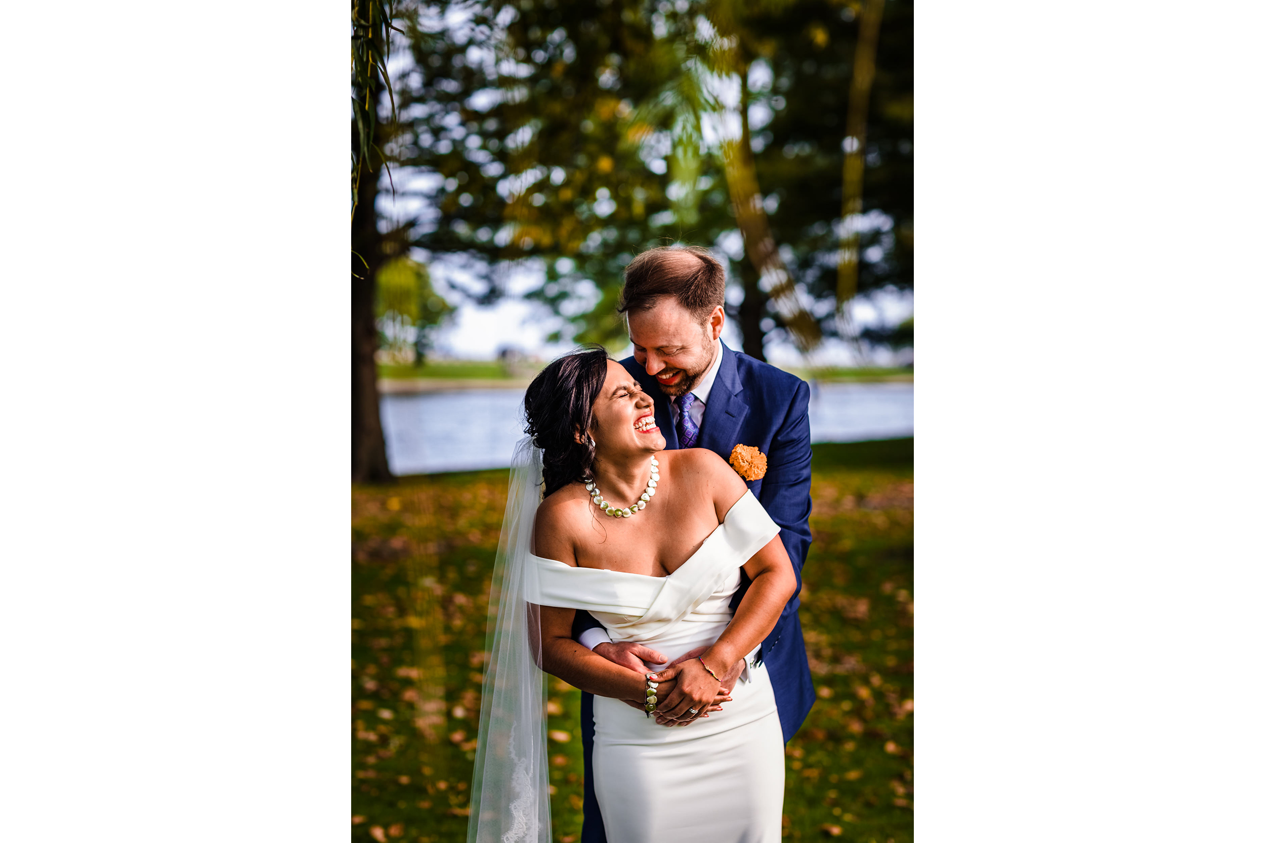 A couple laughs together while taking wedding portraits in Lincoln Park.