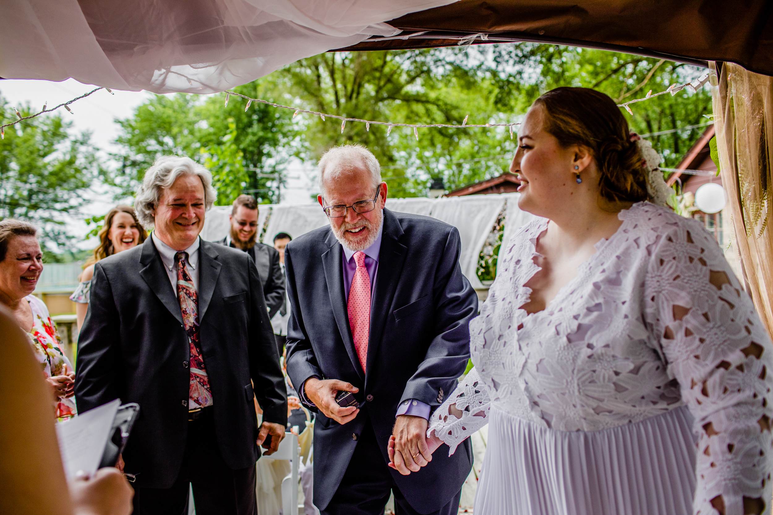 A bride walks down the aisle with her father during a New Lenox backyard wedding.