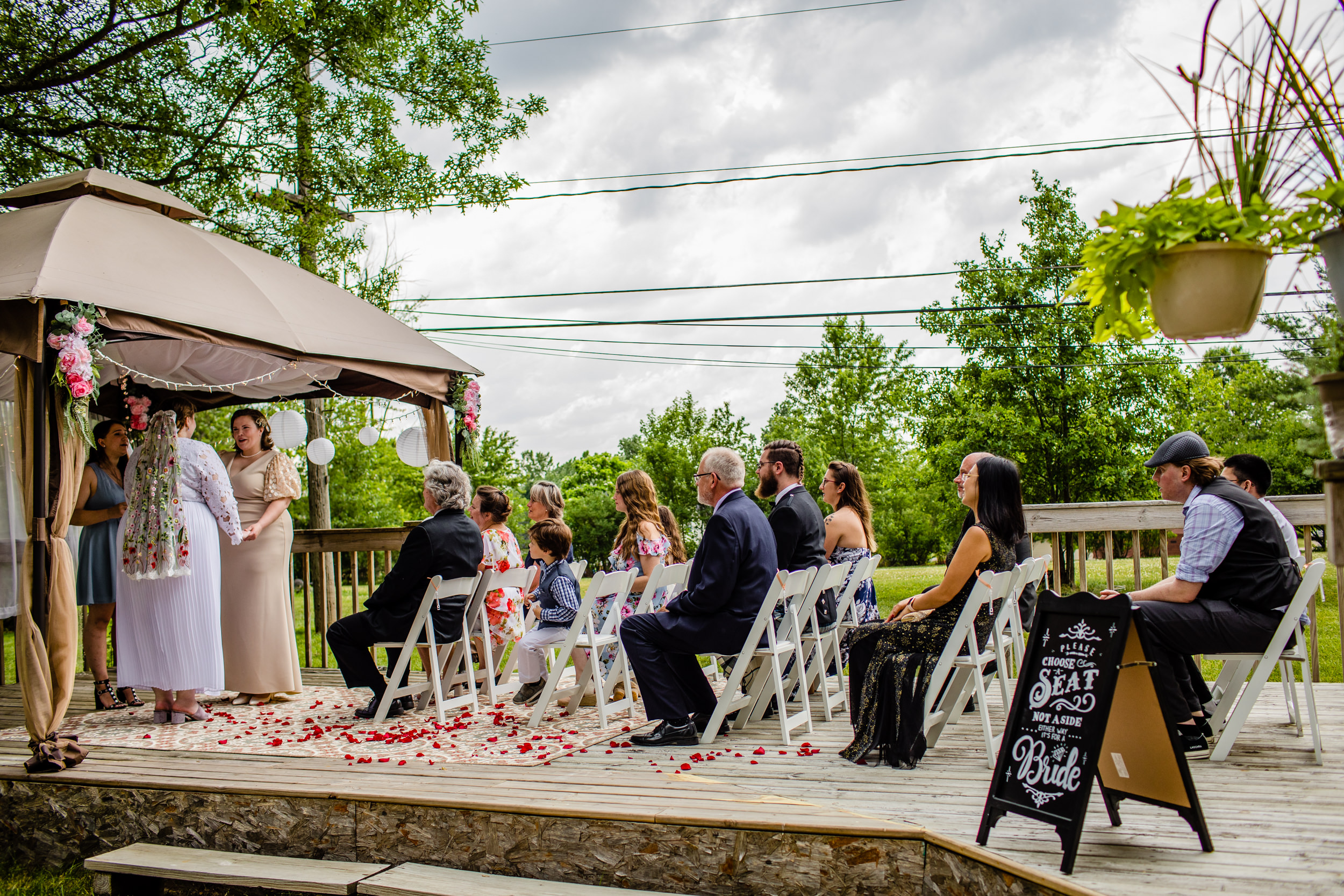 Guests listen to a couple share their vows during a New Lenox backyard wedding.