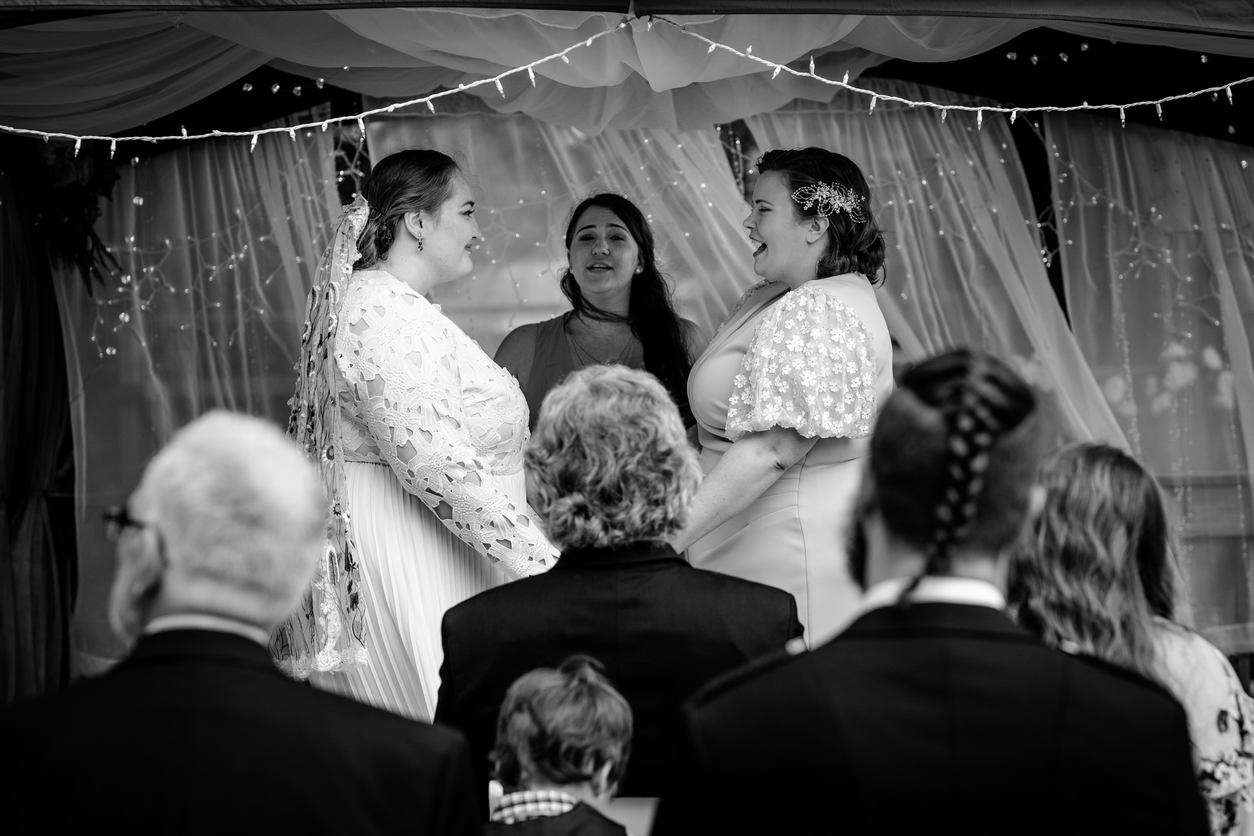 Guests listen to a couple share their vows during a New Lenox backyard wedding.