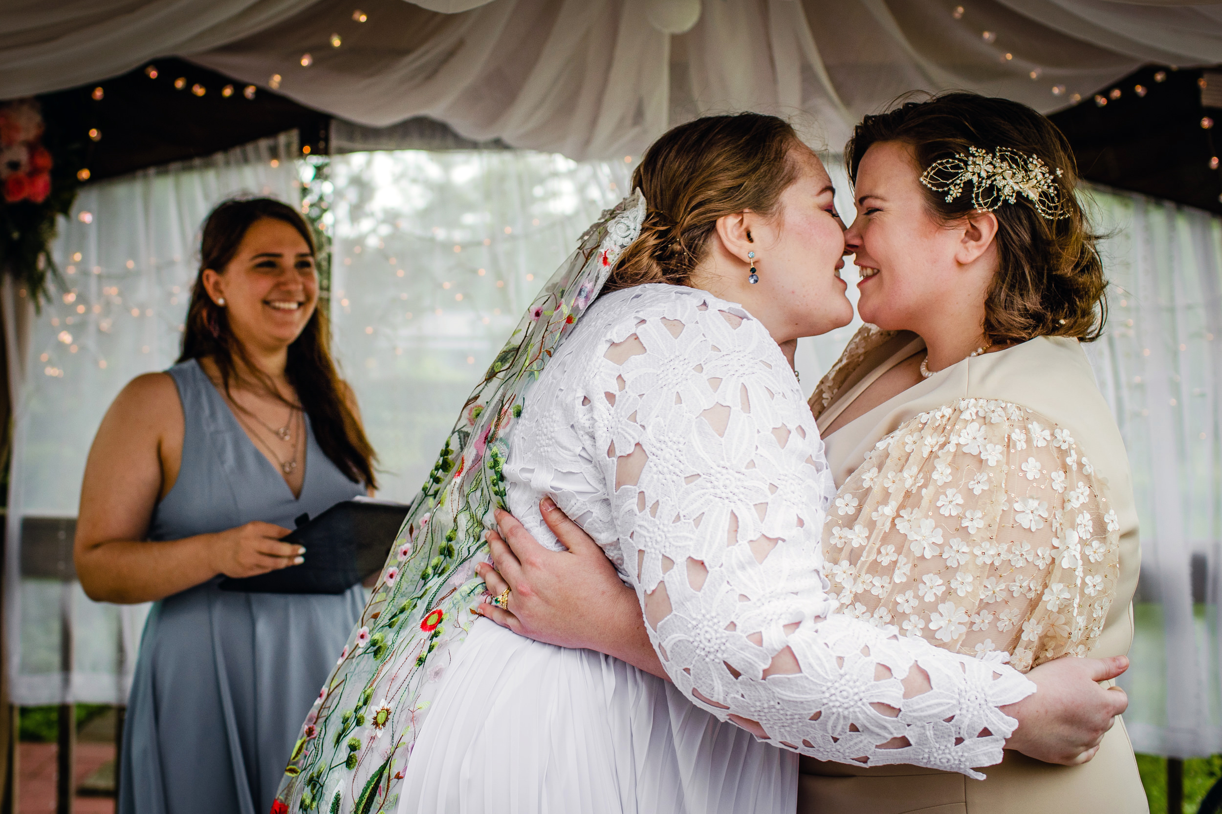 Brides share a first kiss during a backyard wedding in New Lenox, Illinois.